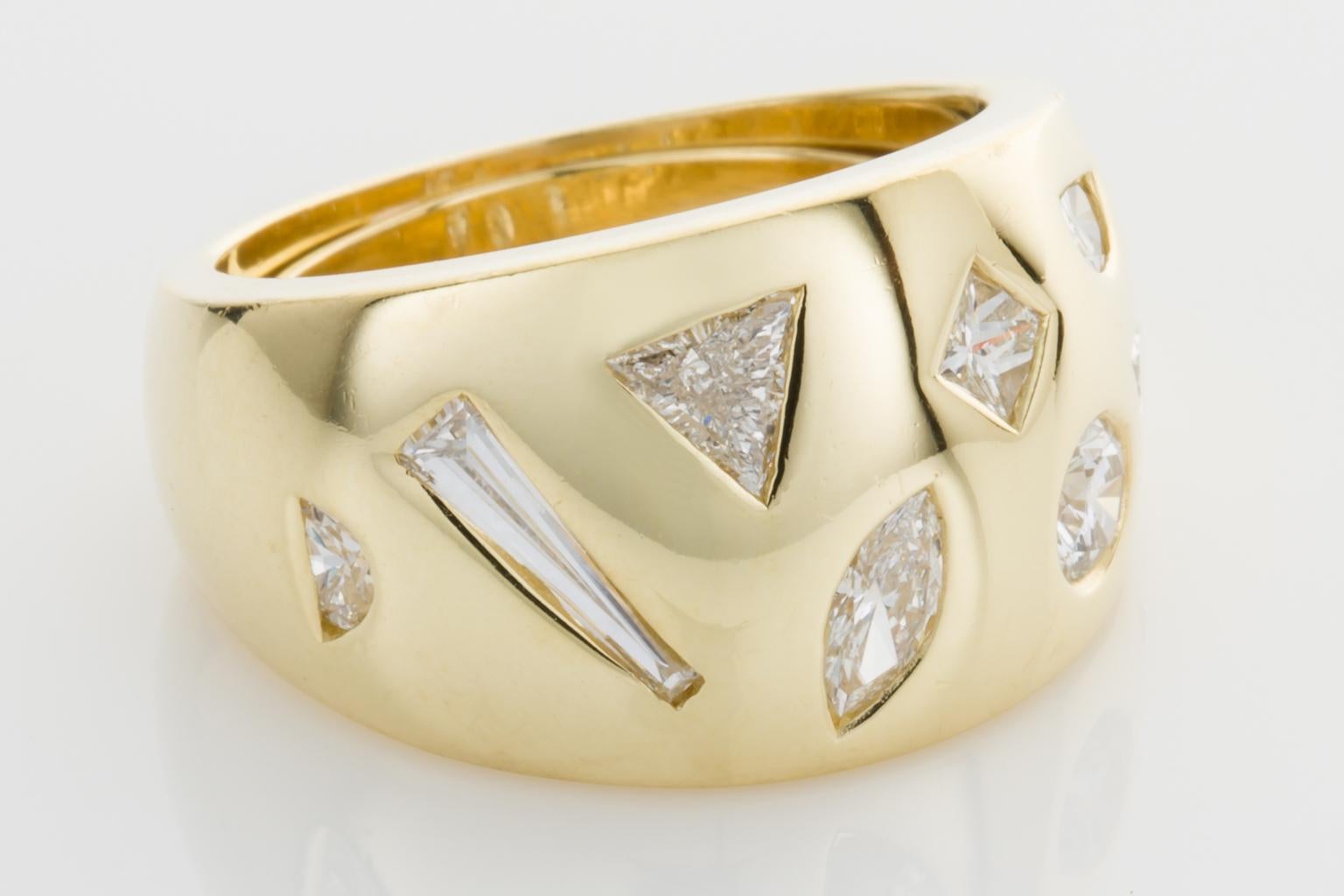 Bold and Beautiful, this 18k Yellow gold ring sits perfectly on the finger.  It's striking with 8 diamonds of multi-cut design, allowing light and sparkle to spread in all directions.  Set with approximately 1.40cts of diamonds, a pear cut, a half