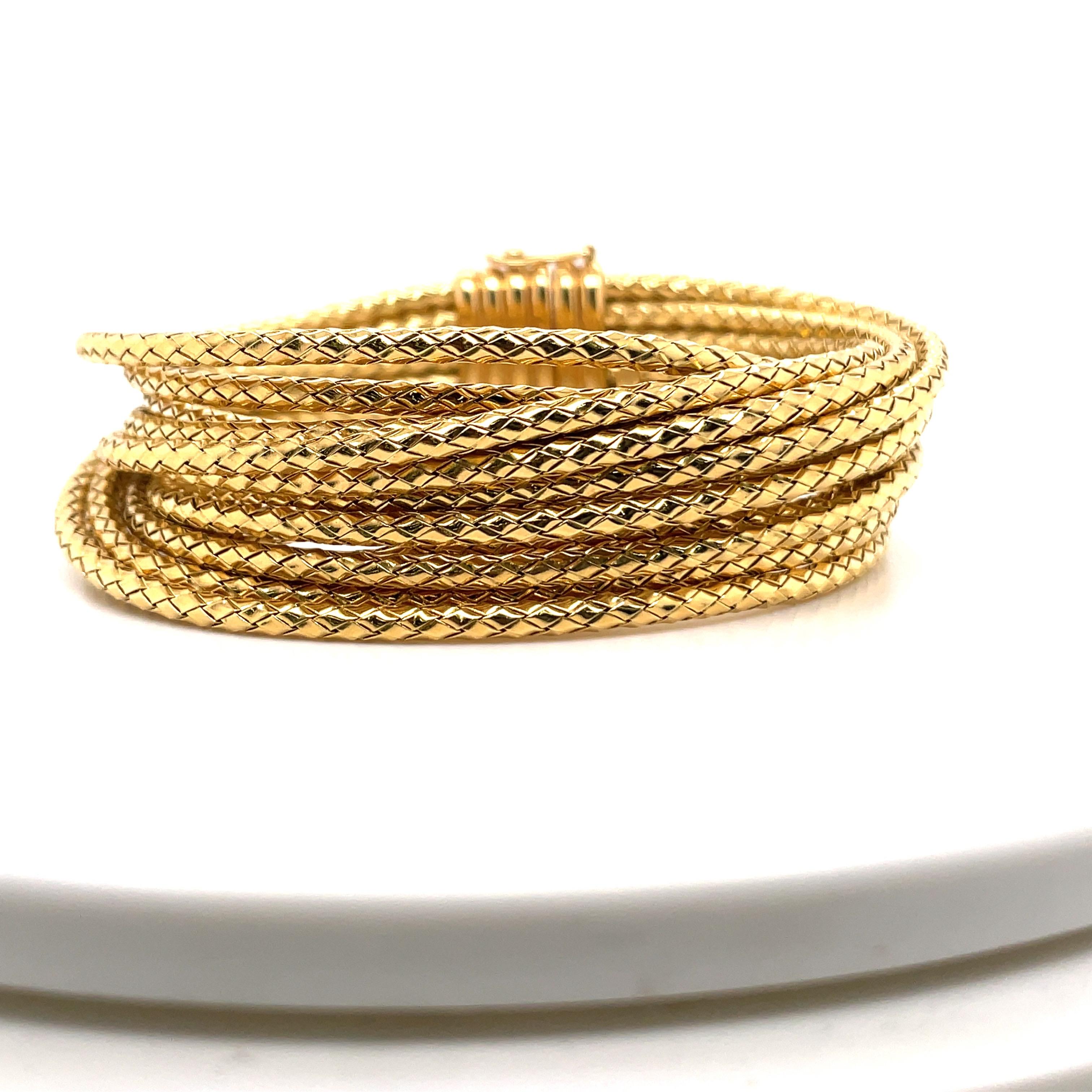18 Karat Yellow Gold bracelet featuring 13 multi textured rope motif weighing 77.2 grams. Stamped 750 ROMA
Very comfortable!
Matching Necklace Available. 
More Gold Bracelets In Stock. 
