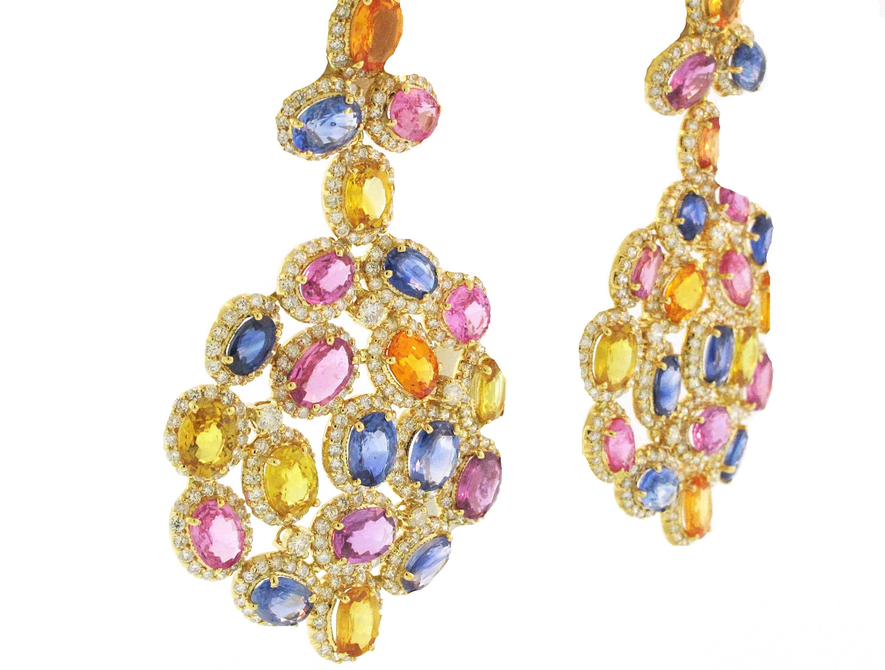 These bright, bold and colorful chandelier earrings are set in 18 Karat Yellow Gold. They are made with 36.85 carats of multi colored sapphires and 7.87 carats of diamonds. 

Earrings measure 6.5 cm long x  3.75 cm wide. 