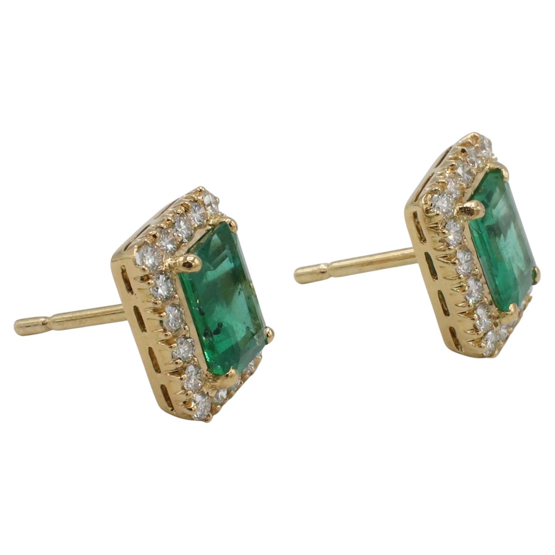 18 Karat Yellow Gold Natural Diamond & Green Emerald Stud Earrings 
Metal: 18k yellow gold
Weight: 5.89 grams
Diamonds: Approx. 1.00 CTW G-H VS round natural diamonds
Emeralds: 7.5 x 5.7mm, approx. 1.10 carats each stone
Dimensions: 9 x 12mm
Backs: