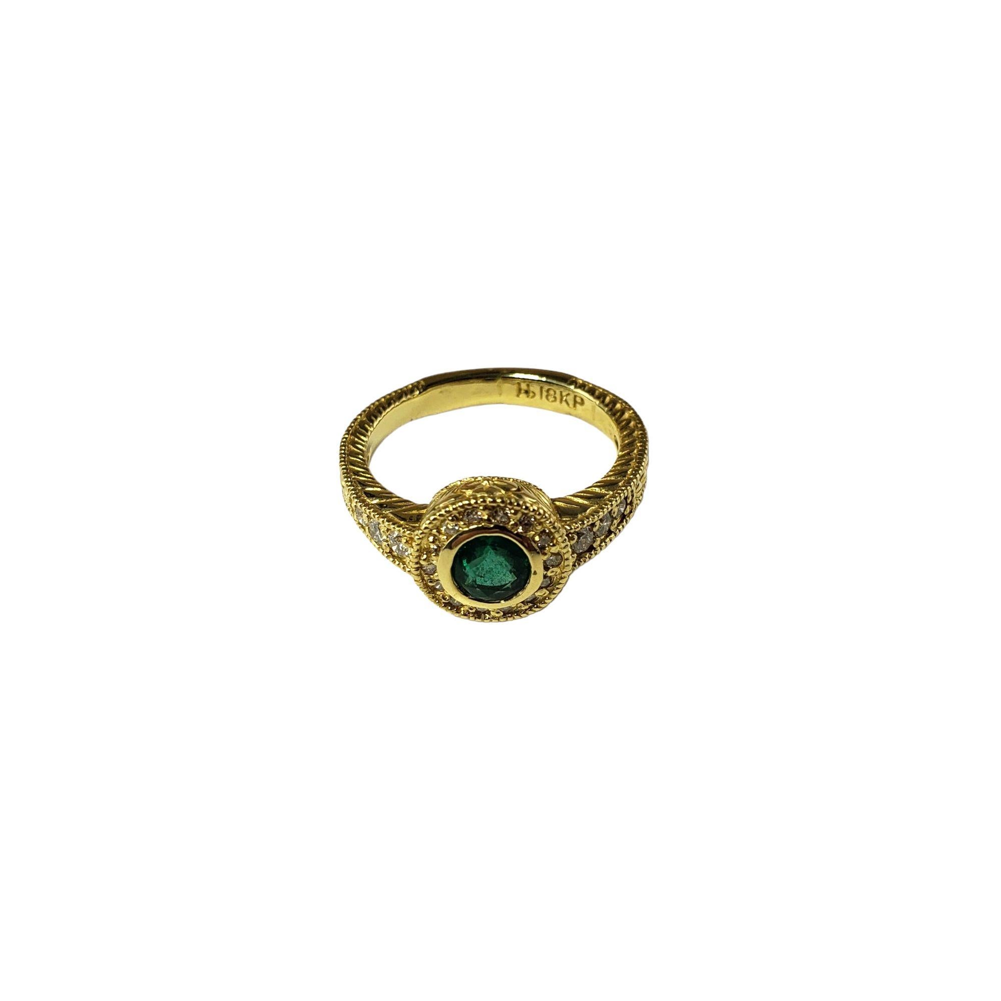 This lovely ring features features one round emerald and 20 round brilliant cut diamonds set in 18K yellow gold.

Width: 9 mm.  Shank: 3 mm.

Approximate total diamond weight:  .20 ct.

Diamond color:  G-H

Diamond clarity:  VS2

Size:  7

Weight: 