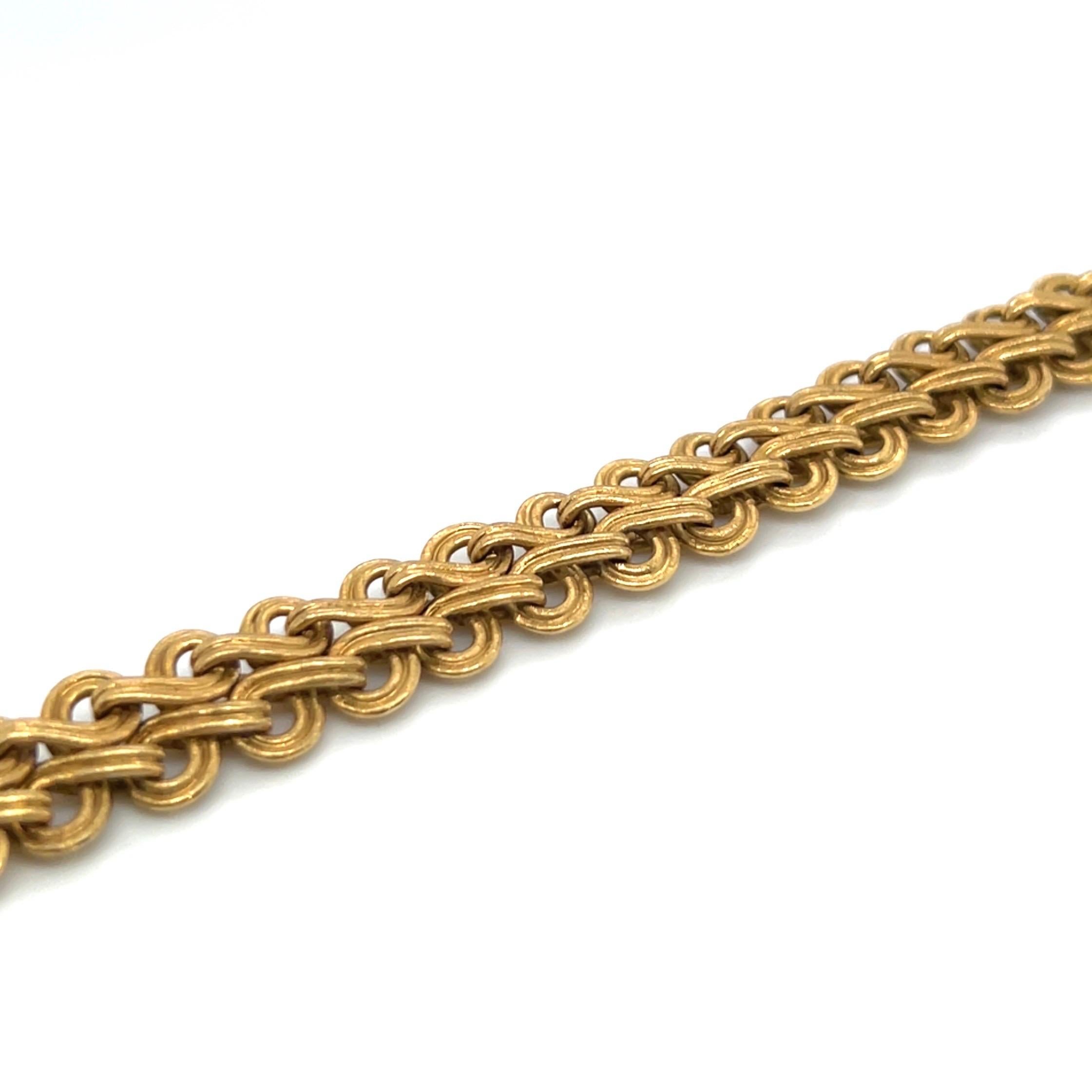 Timeless 18 karat yellow gold necklace by renowned Italian jeweler Gianmaria Buccellati, 1960s.

Crafted in 18 karat matte-finished yellow gold, this necklace features an intricate and woven design. Interconnected gold links create a pattern that