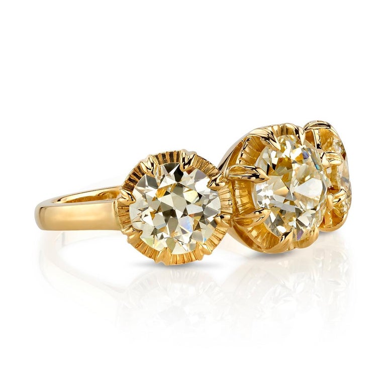3.35ct L-N/ VS1-VS2 old European cut diamonds set in a handcrafted 18k yellow gold three stone mounting. Ring is currently a size 6 and can be sized to fit. 