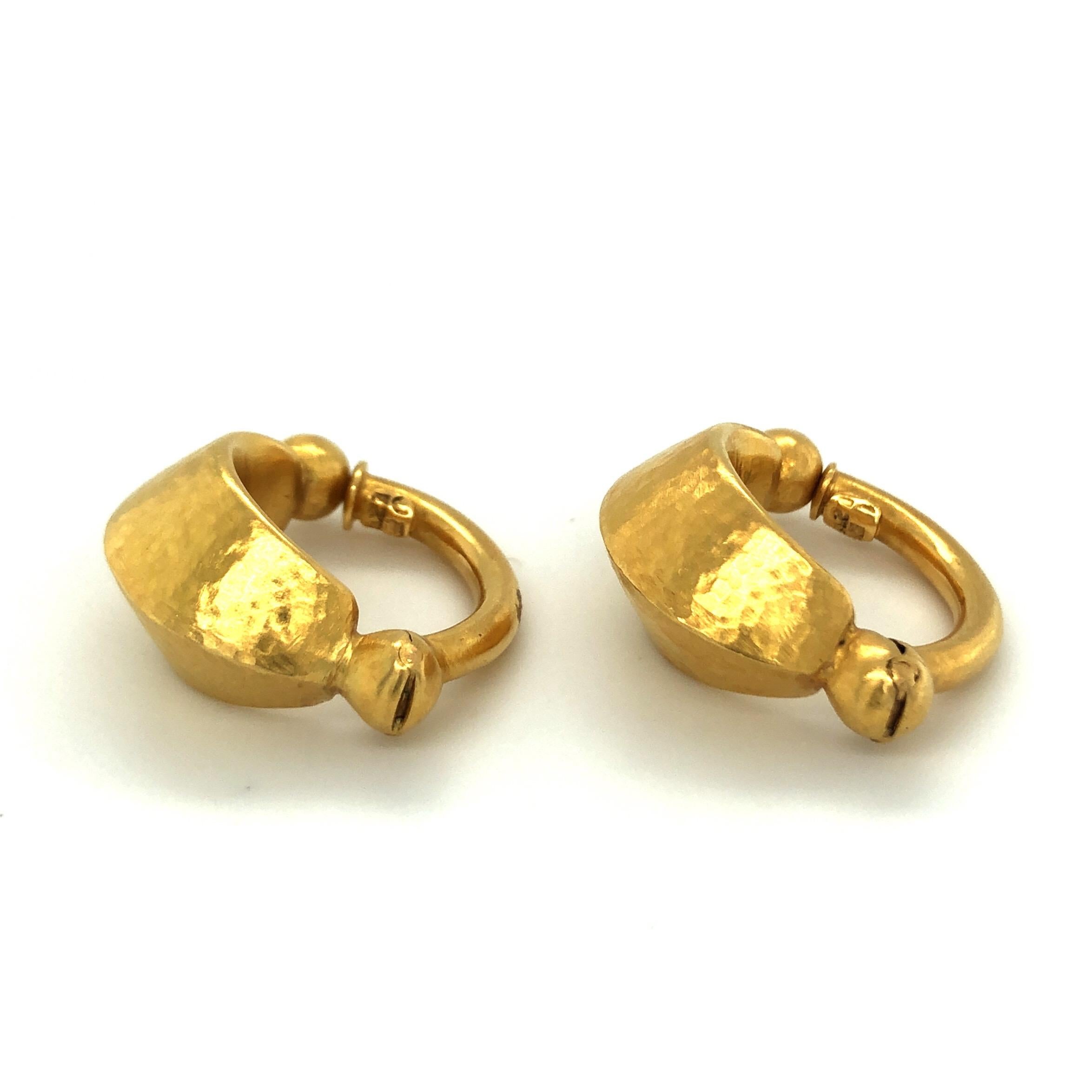 18 karat yellow gold Neolithic hoop earrings by Lalaounis.
Pair of prehistoric style hoop earrings handcrafted in 18 karat yellow hammered gold, each designed as a textured, bevelled and tapered hoop with spherical terminals. Suitable for unpierced