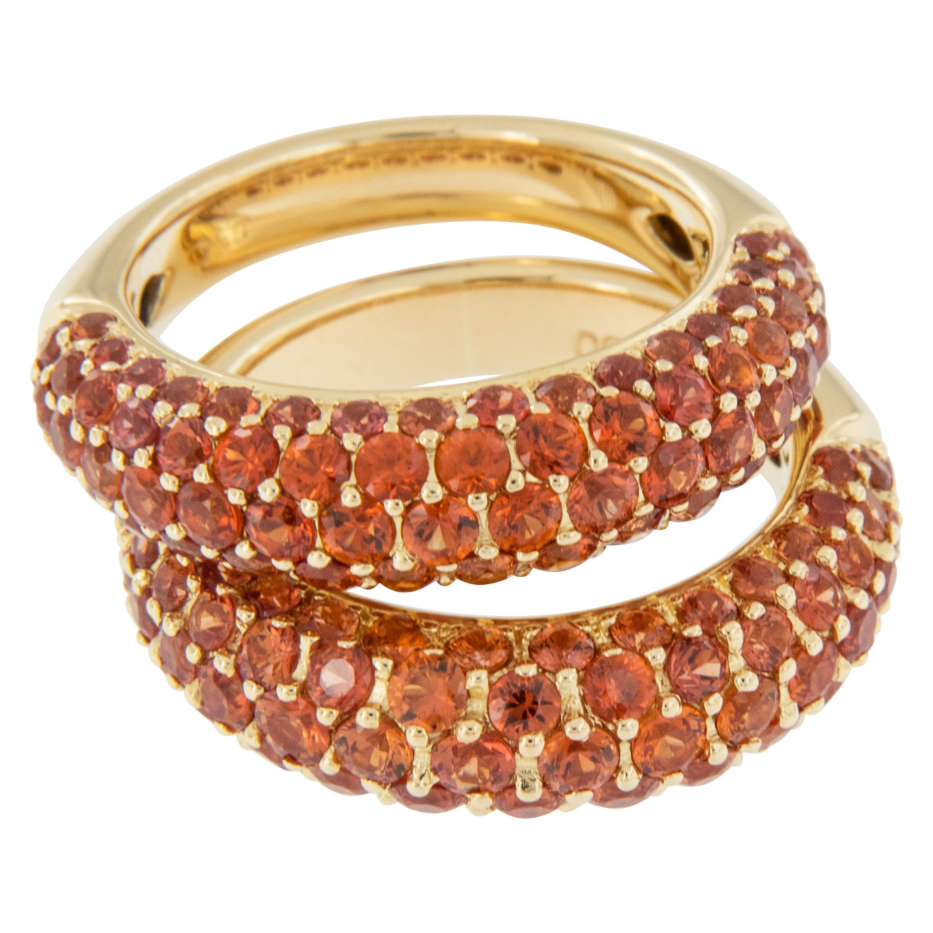 Classic describes this Fancy Orange Sapphire ring! Orange is one of the more rare colors of fancy sapphires and it is obtained by trace elements. Created in 18 karat yellow gold, this Bombe' style band ring contains 84 orange sapphires bead set =