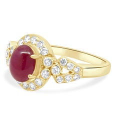 18 Karat Yellow Gold Oval Cabochon Cut Ruby and Round Diamond Halo Ring