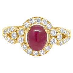 18 Karat Yellow Gold Oval Cabochon Cut Ruby and Round Diamond Halo Ring