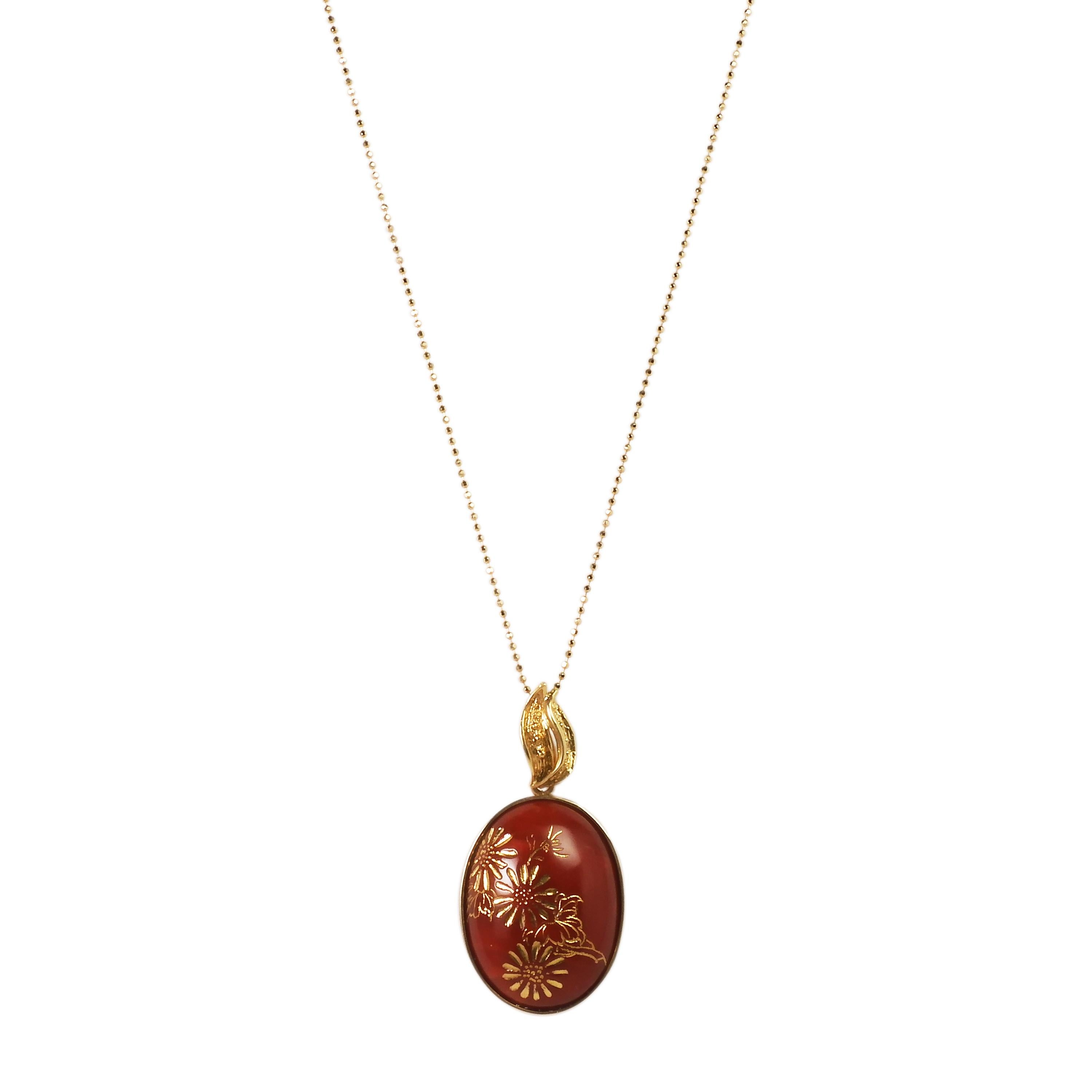 This is a classic Chiaka Sango (Oxblood Coral) pendant with a chrysanthemum engraving. There is no white spot on the surface and the color is the typical deep dark red of the oxblood coral. The petals and leaves of the chrysanthemum have been carved