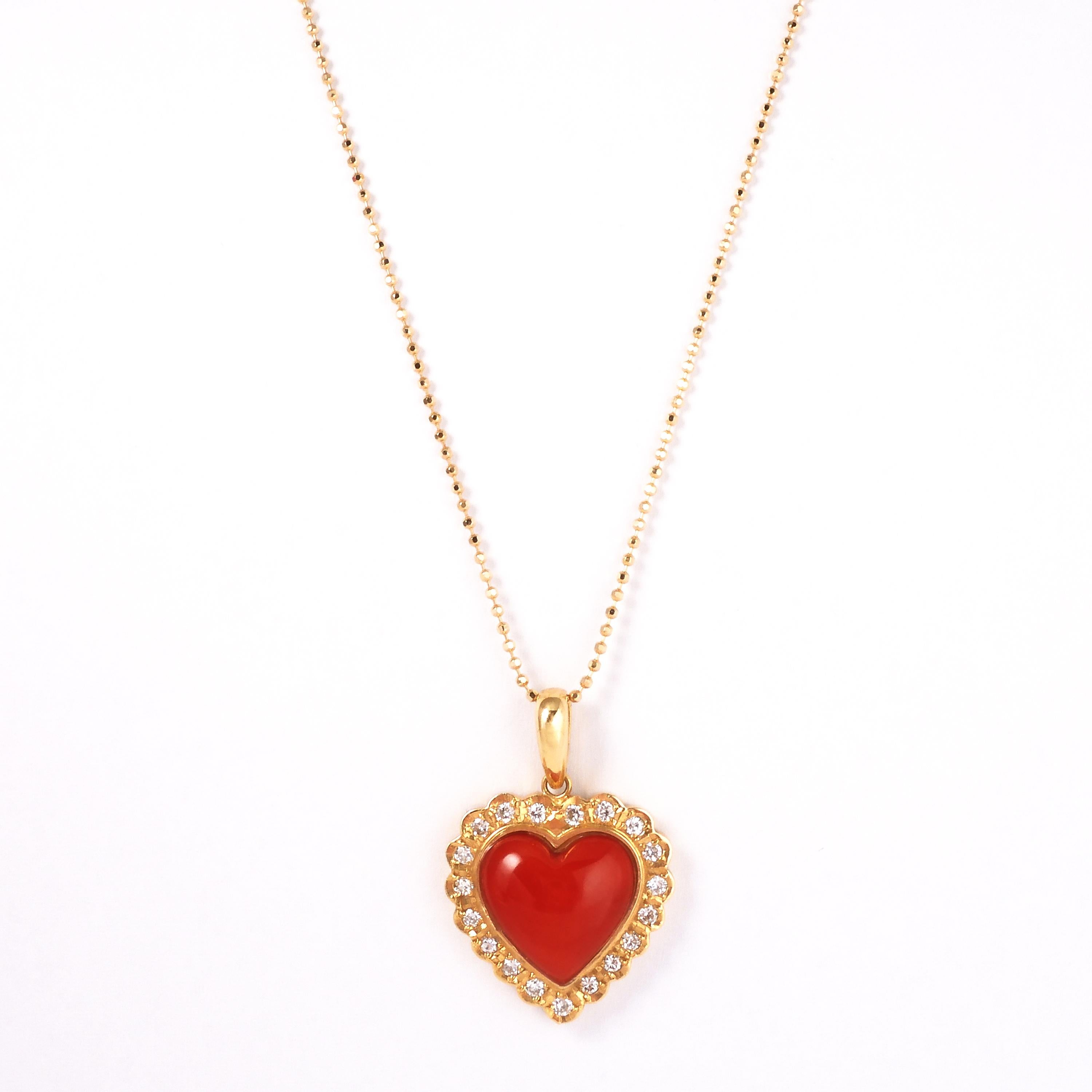 Heart-shaped Chiaka Sango(Oxblood Coral) pendant top set in a well crafted 18 karat yellow gold bezel  is elegantly accented with diamonds weighing approx. 0.24 carats.

This item doesn't include the chain.

About the coral: among the red coral,