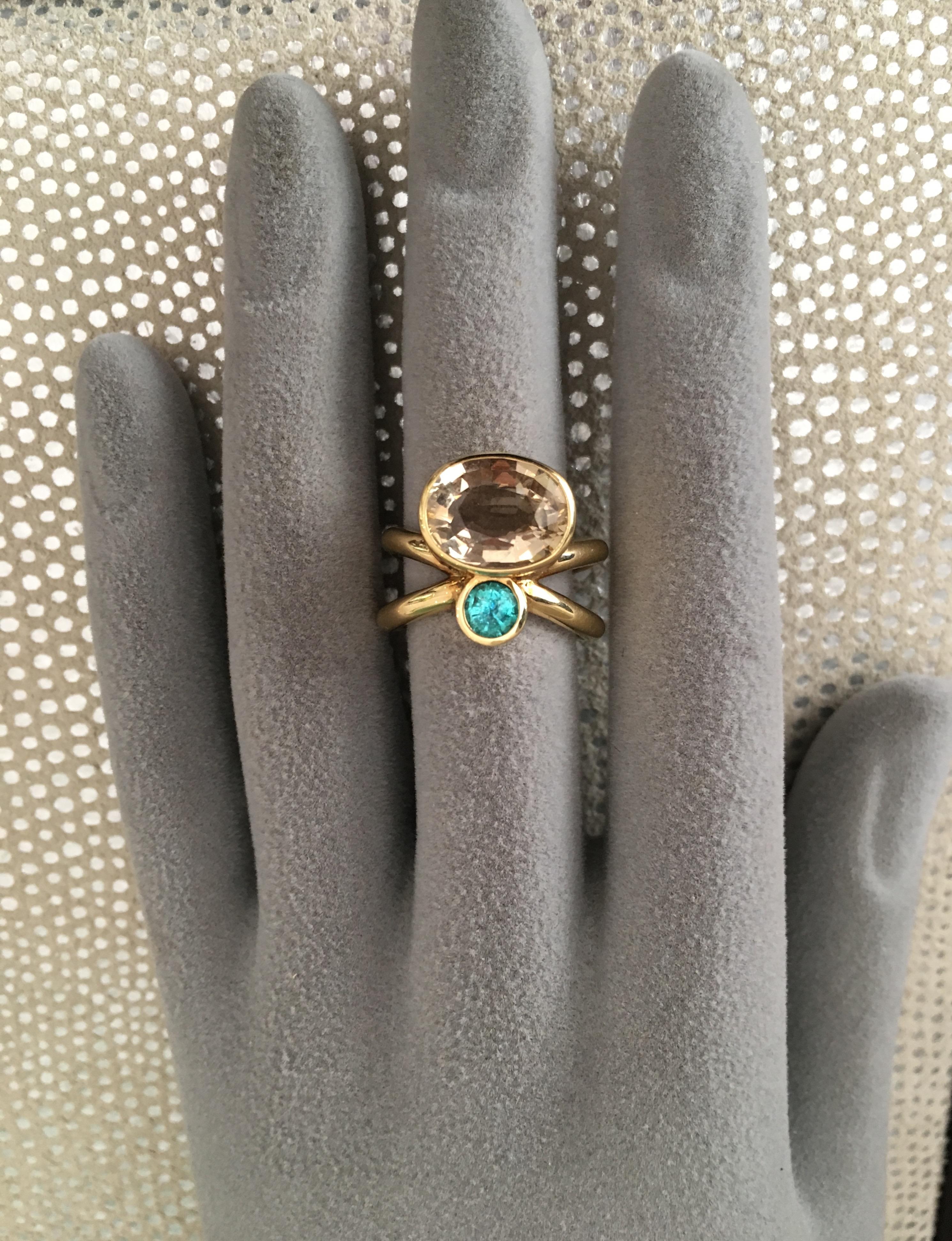 Paraiba and champagne tourmaline cross over ring in 18 Karat yellow gold.
Champagne oval tourmaline 3.31cts
Paraiba Brazil 0.28cts

Ring size: 
American 6
European 52