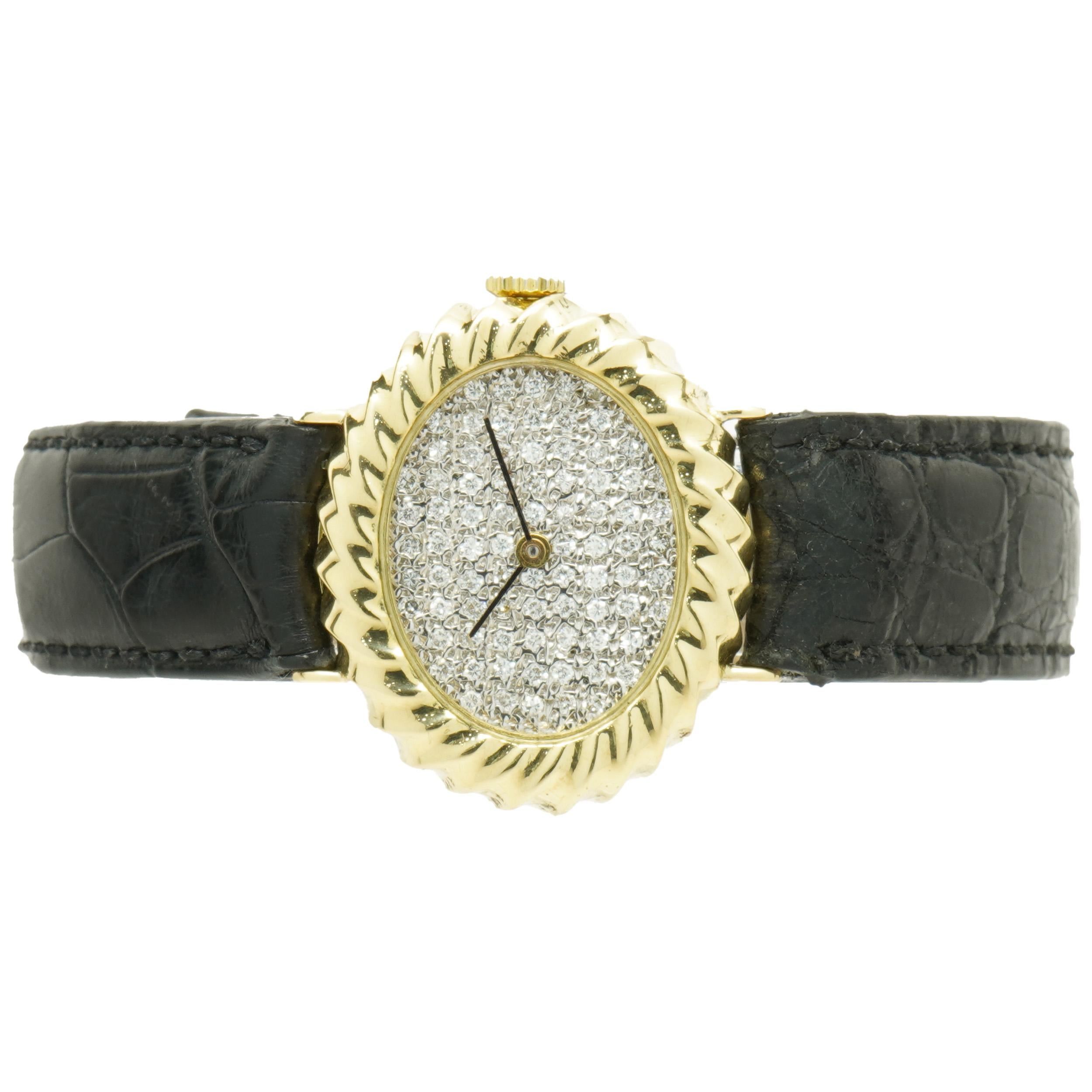 Movement: Manual wind
Function: hours, minutes
Case: 33 x 24.5mm oval case, sapphire crystal, 18K yellow gold cable bezel 
Band: black leather strap, buckle
Dial: pave diamond
Does not come with original box or paperwork.
Guaranteed to be authentic