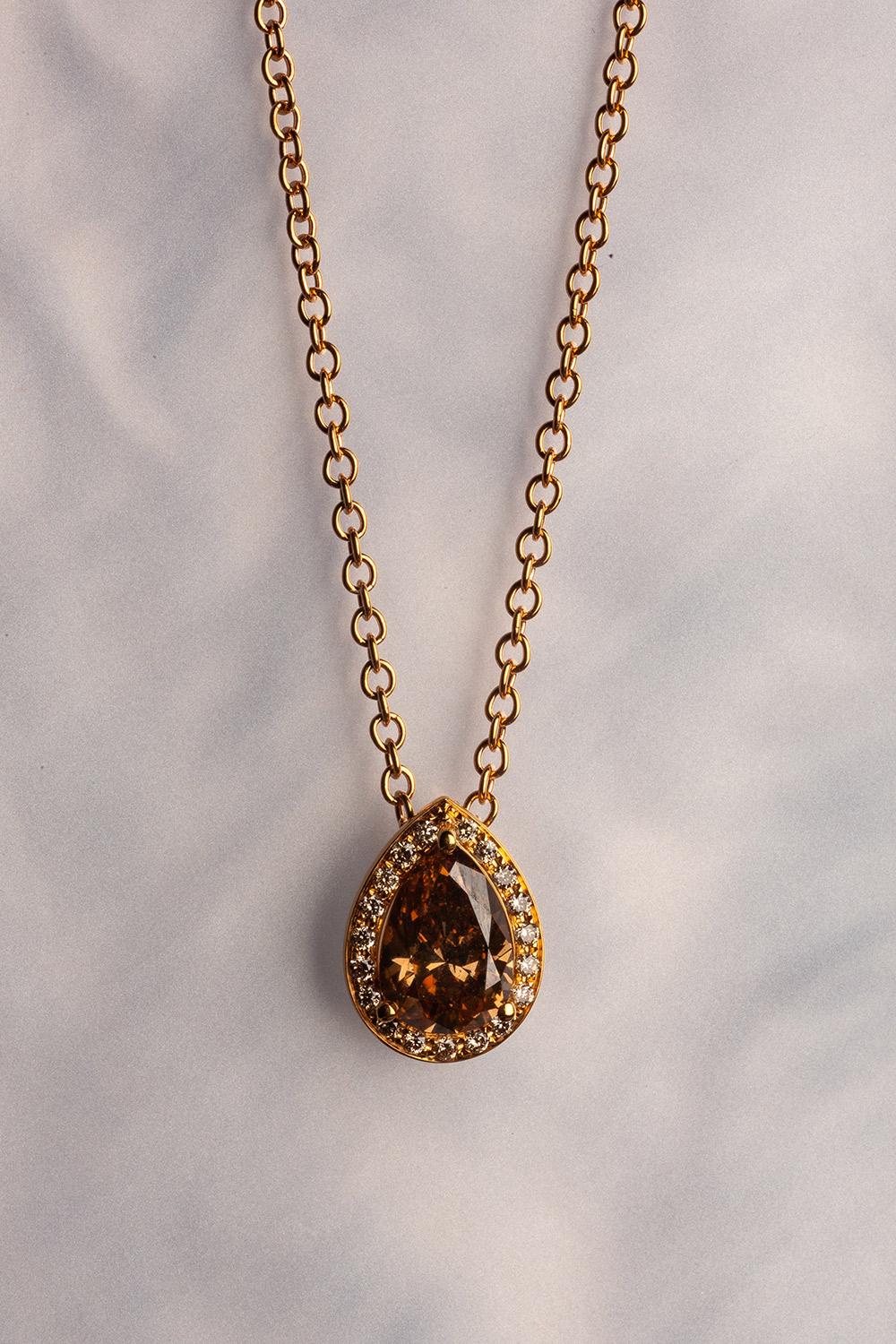 This 18K yellow gold elegant pendant is from our Divine Collection. It is made of a pear shape brown diamond in total of 1.08 Carat decorated by round brown diamonds in total of 0.07 Carat. Total metal weight is 4.75 gr. The pendant is 1cm long, the