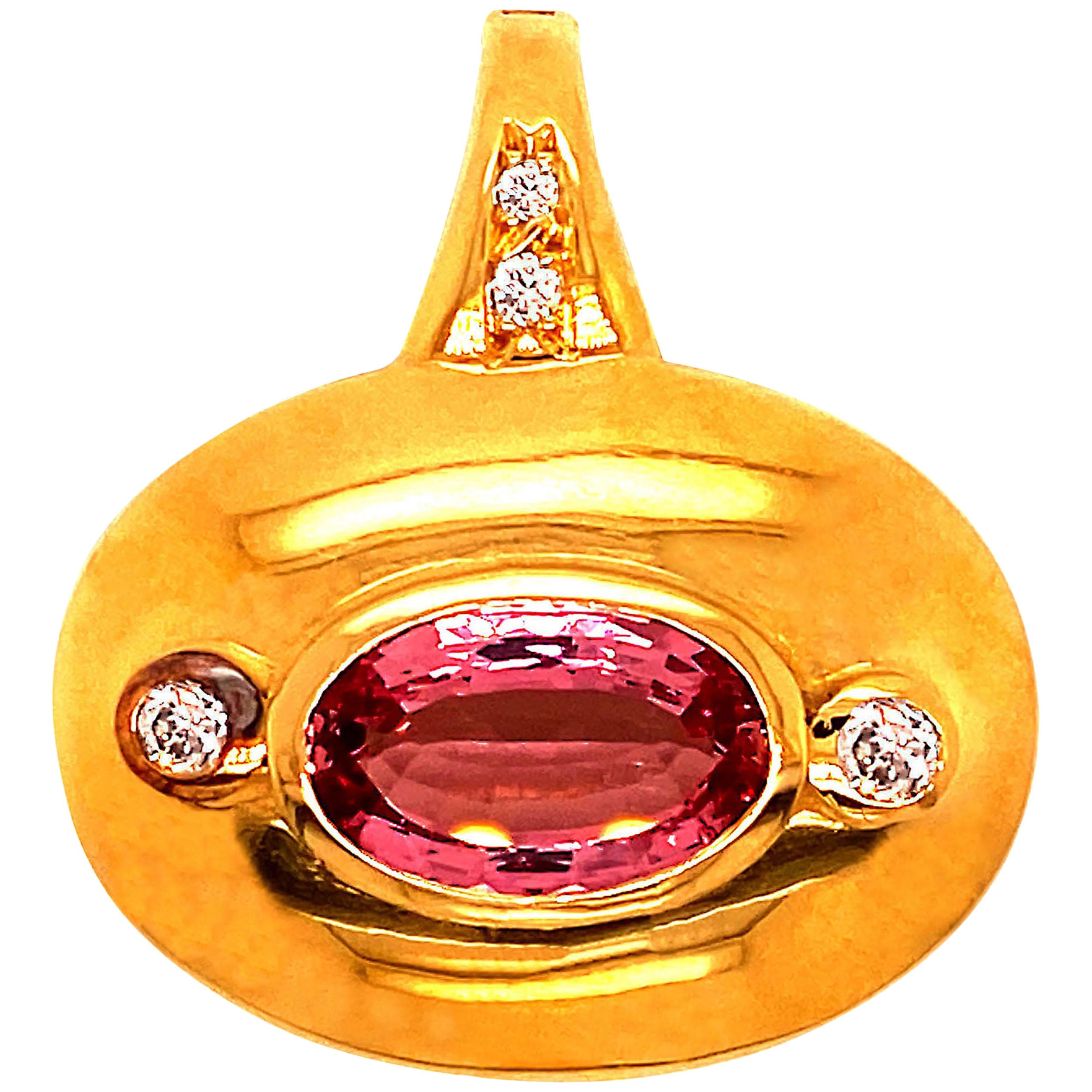 This one of a kind pendant was hand made in Rio de Janeiro with a gorgeous brazilian Tourmaline. Large 18K rich yellow gold shield style pendant featuring an east-west set light-medium color, oval step cut pink Tourmaline, 14 X 9 X 5 MM, est 4.6 ct
