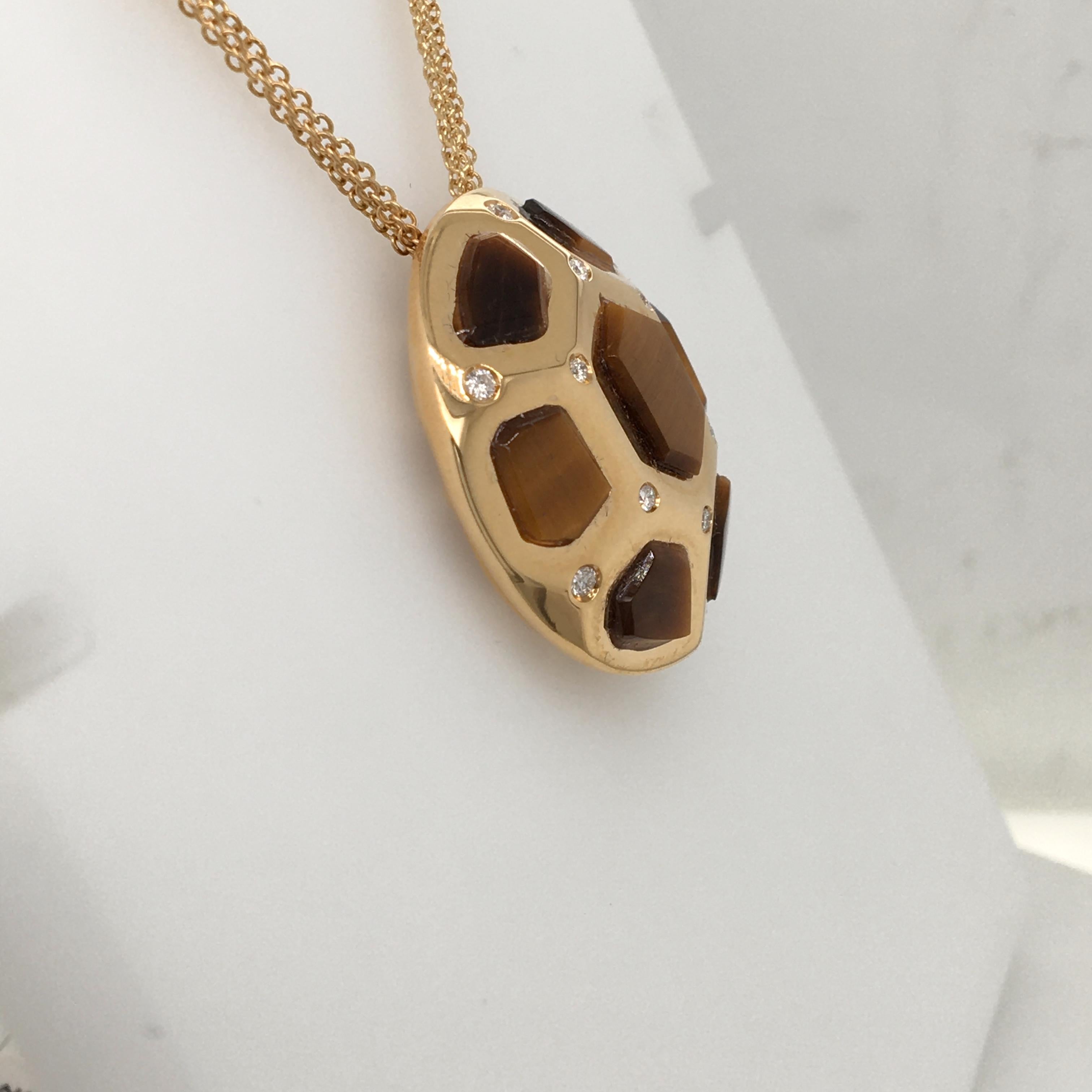 18 Karat yellow gold pendent  set with diamonds and tiger eye stones, tiger eye have been recut on the exact size of the frame, the pendent has a very nice gallery on the back, with multichain (3 chains) Made In Italy, comes in a box, chain length
