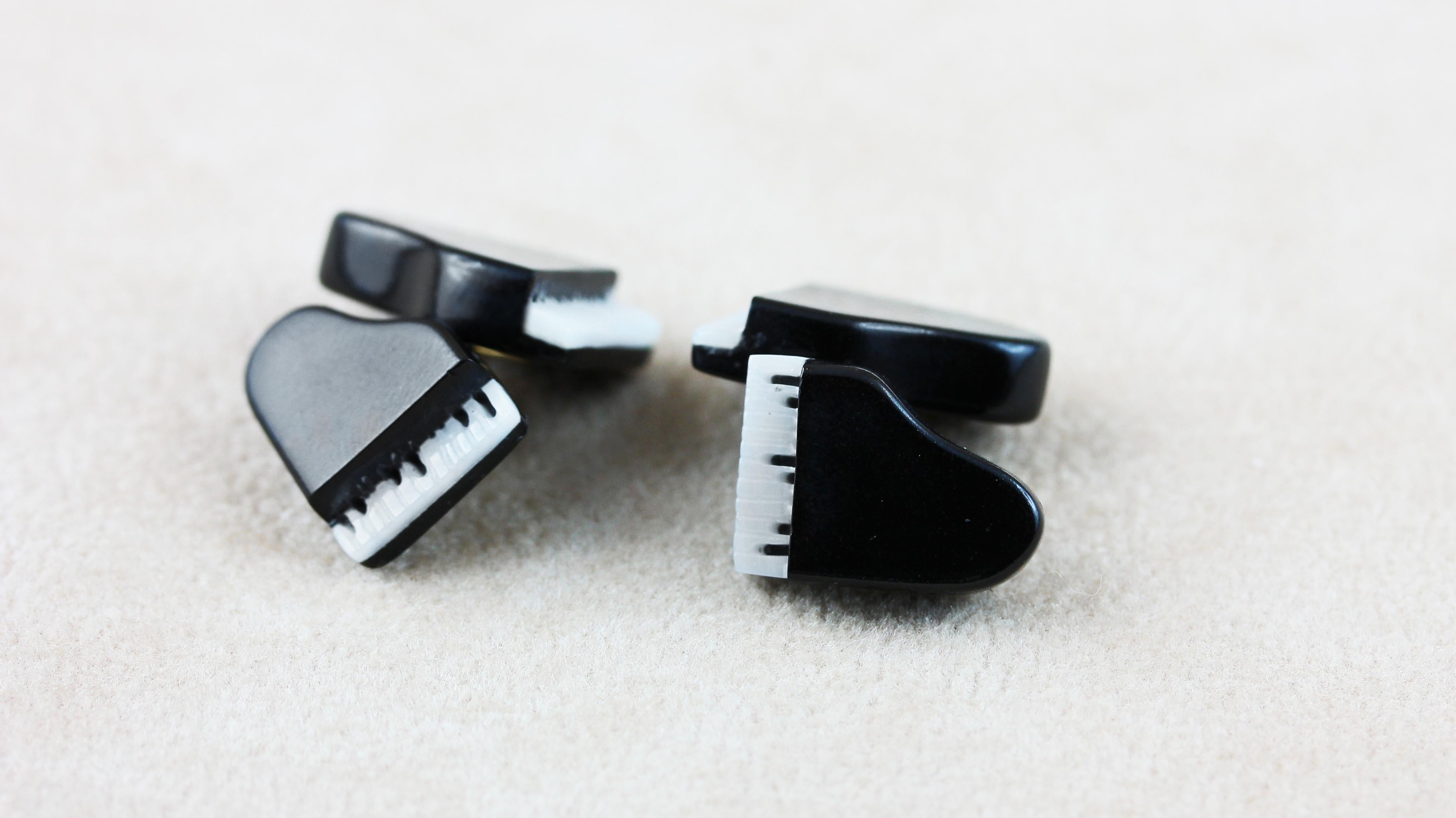The piano is a wonderful classical instrument, and these music inspired cufflinks will add a truly classical look to any outfit.
In this pair of cufflinks the front face and the toggle are both hand carved to shape pianos,
two bigger for the front