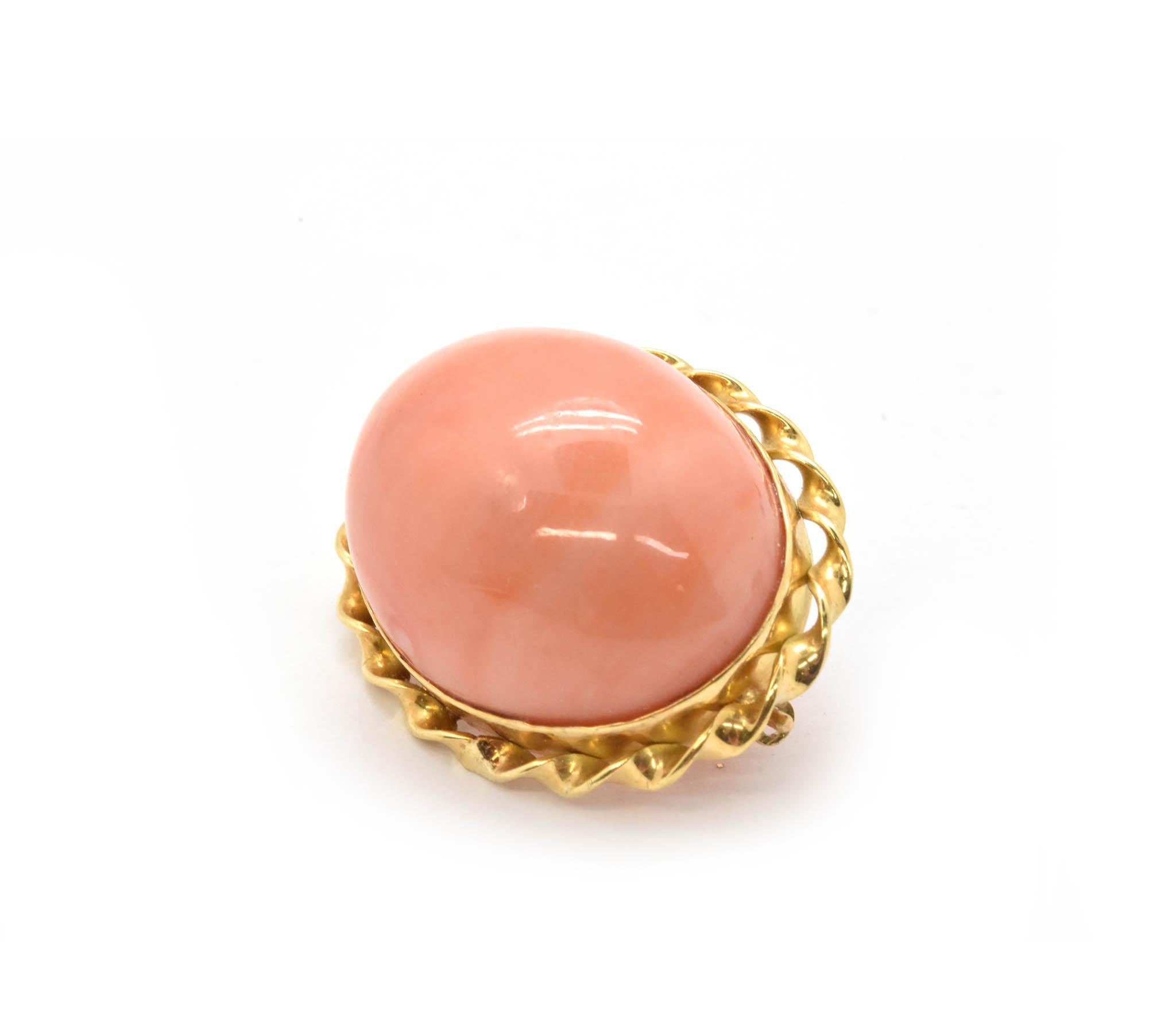 This pink coral pin is made in 18k yellow gold and set into a classy fun yellow gold twisted ribbon border. The coral has a resinous luster and measures 25x19mm. The back of the border has a pin with a safety hole so the pin doesn’t poke you! Total