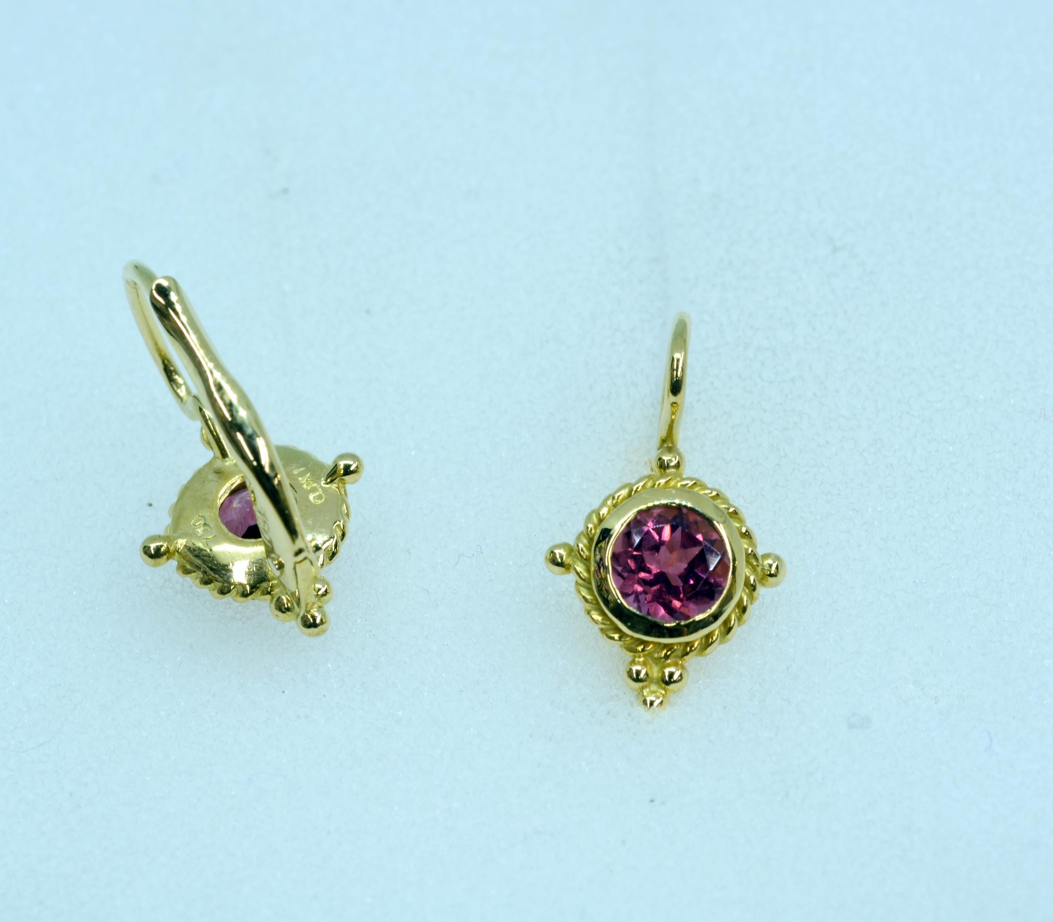 Very sweet pair of 18 Karat Yellow gold drop lever-back earrings. These are set with a pair of 5mm. round faceted pink tourmalines. They are accented with tiny gold beads. They are 8mm. in circumference.