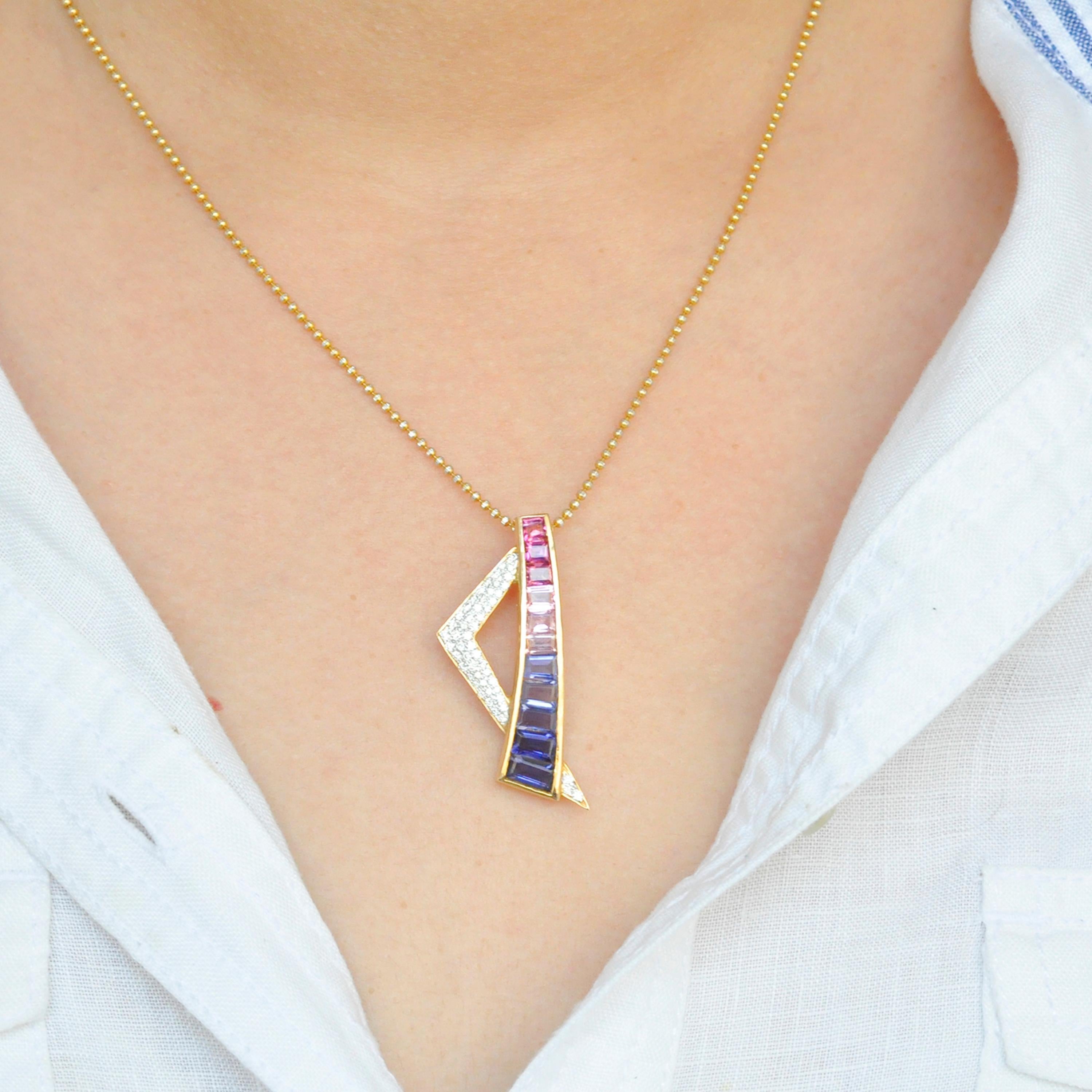 18 karat yellow gold pink tourmaline iolite diamond contemporary pendant. 

This contemporary and edgy pendant is exquisite. The hot pink, baby pink tourmaline and iolites are hand selected in gradation, taper cut and channel set in 18 karat yellow