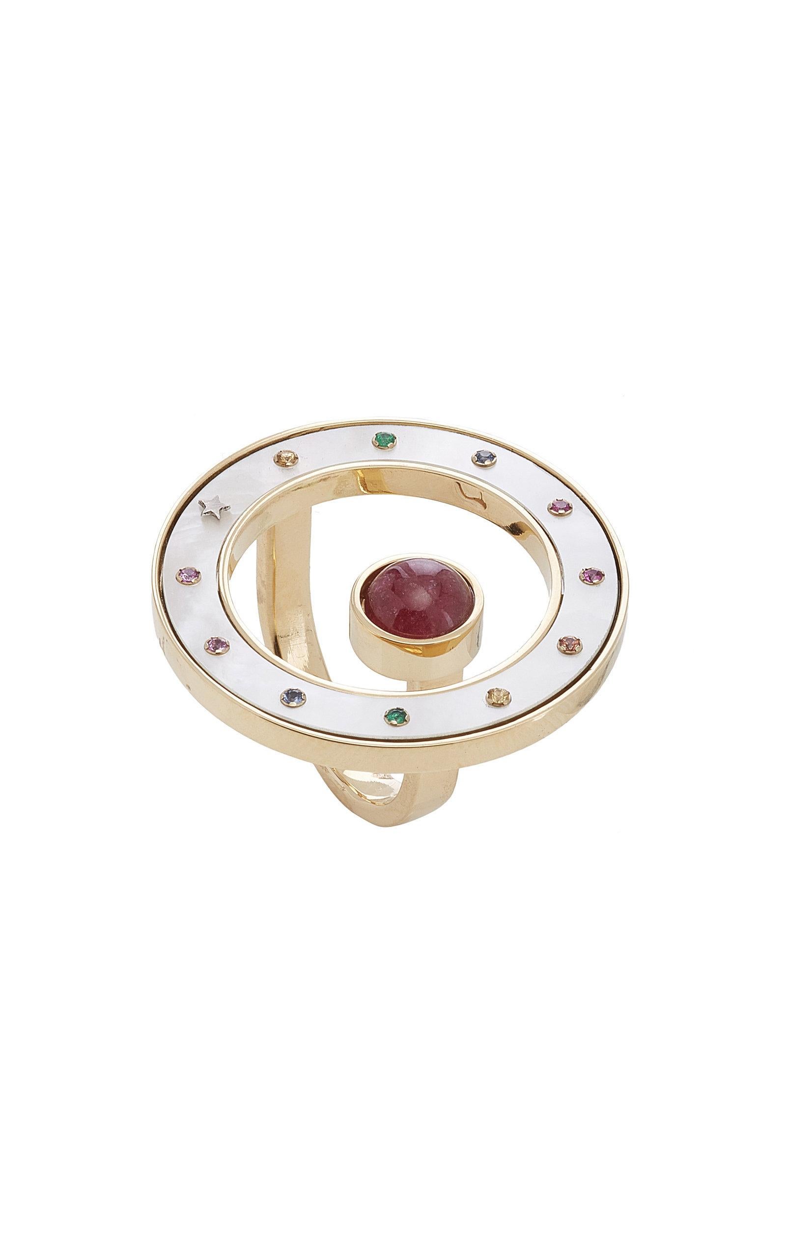 Inspired by the concept of time, Anna Maccieri Rossi's 'ORA Ring' features a circular mother of pearl dial with tourmaline cabochon at center. The 11 multicolored sapphires and a gold star at 8 o'clock are markers of each hour of the day. Slips on.