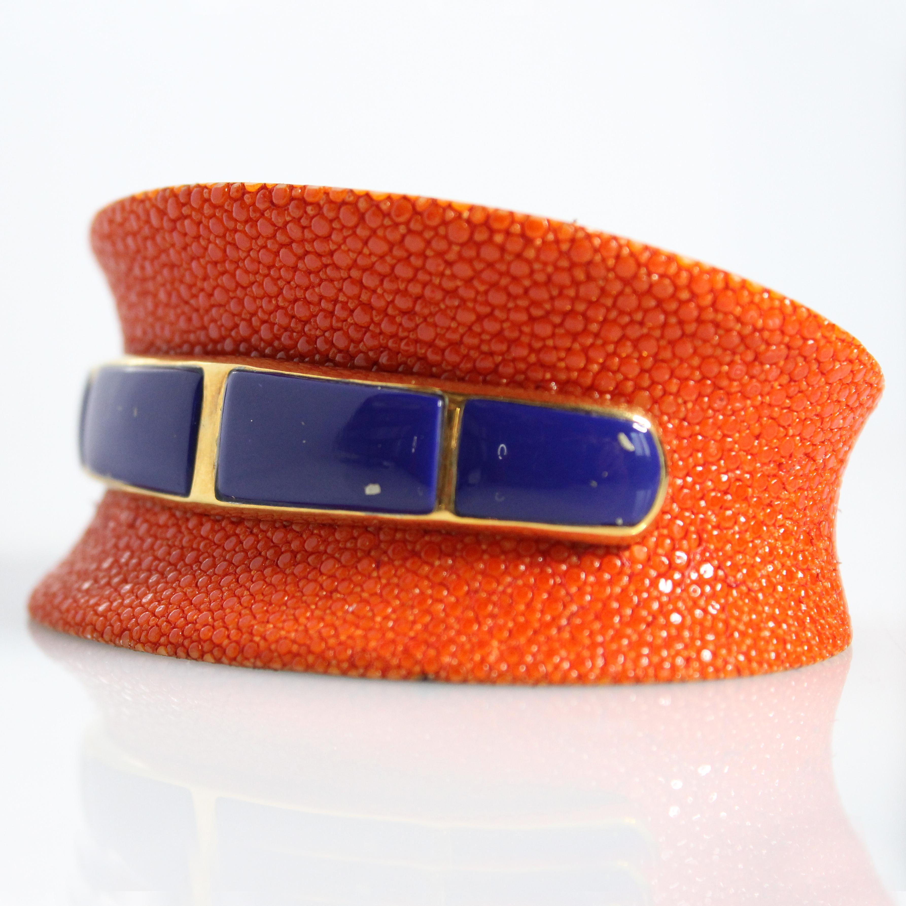 Bracelet made in wood covered by orange galuchat, embellished at the center with lapis lazuli mounted in sterling silver 925, 18 karat yellow gold-plated.

All AVGVSTA jewelry is new and has never been previously owned or worn. Each item will arrive