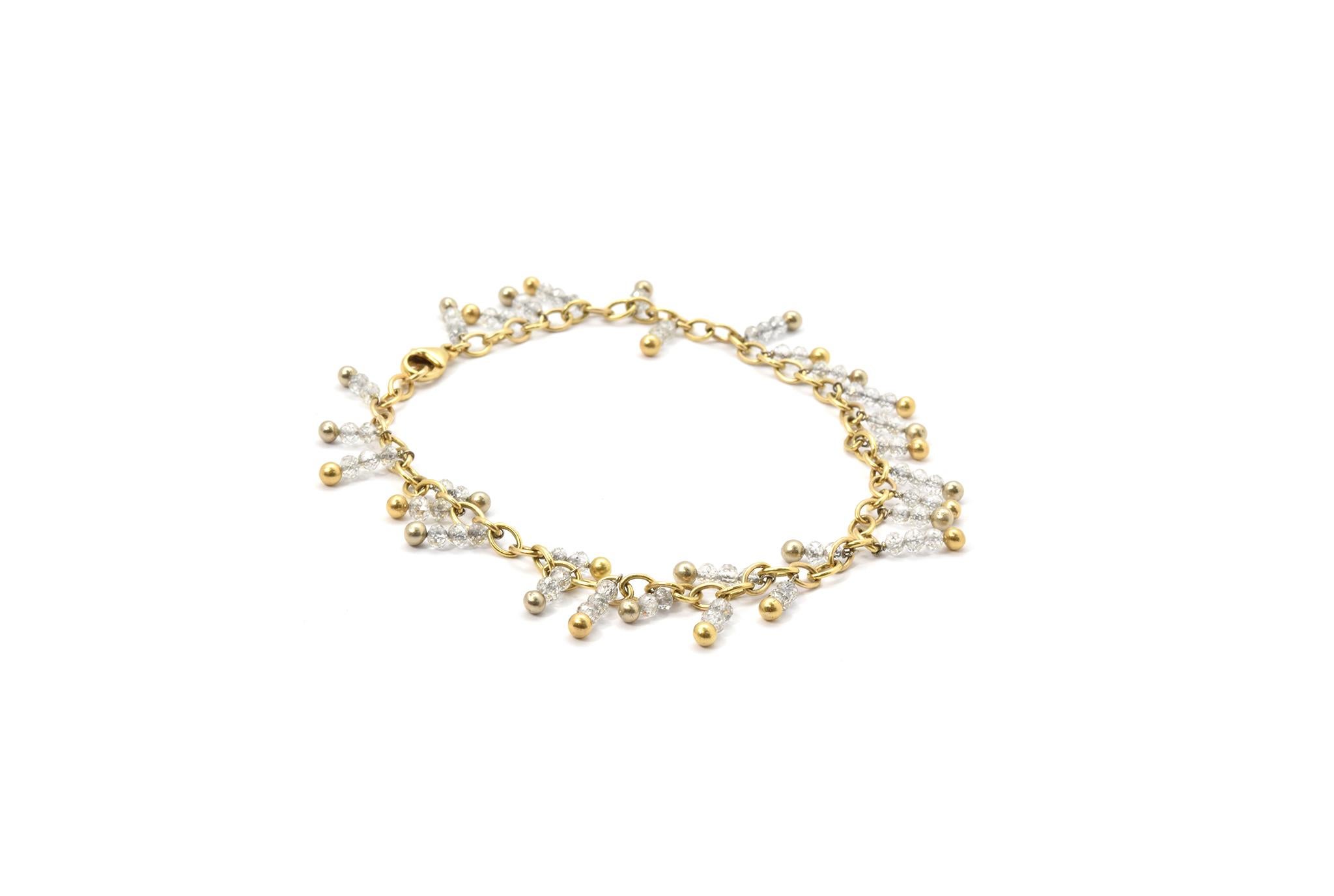 This unique bracelet is made in 18k yellow gold and platinum, and it features several diamond beads for a total approximate weight of 18 carats. The dangles measure up to 12mm long, and the bracelet will fit an ankle measuring up 10 inches around.