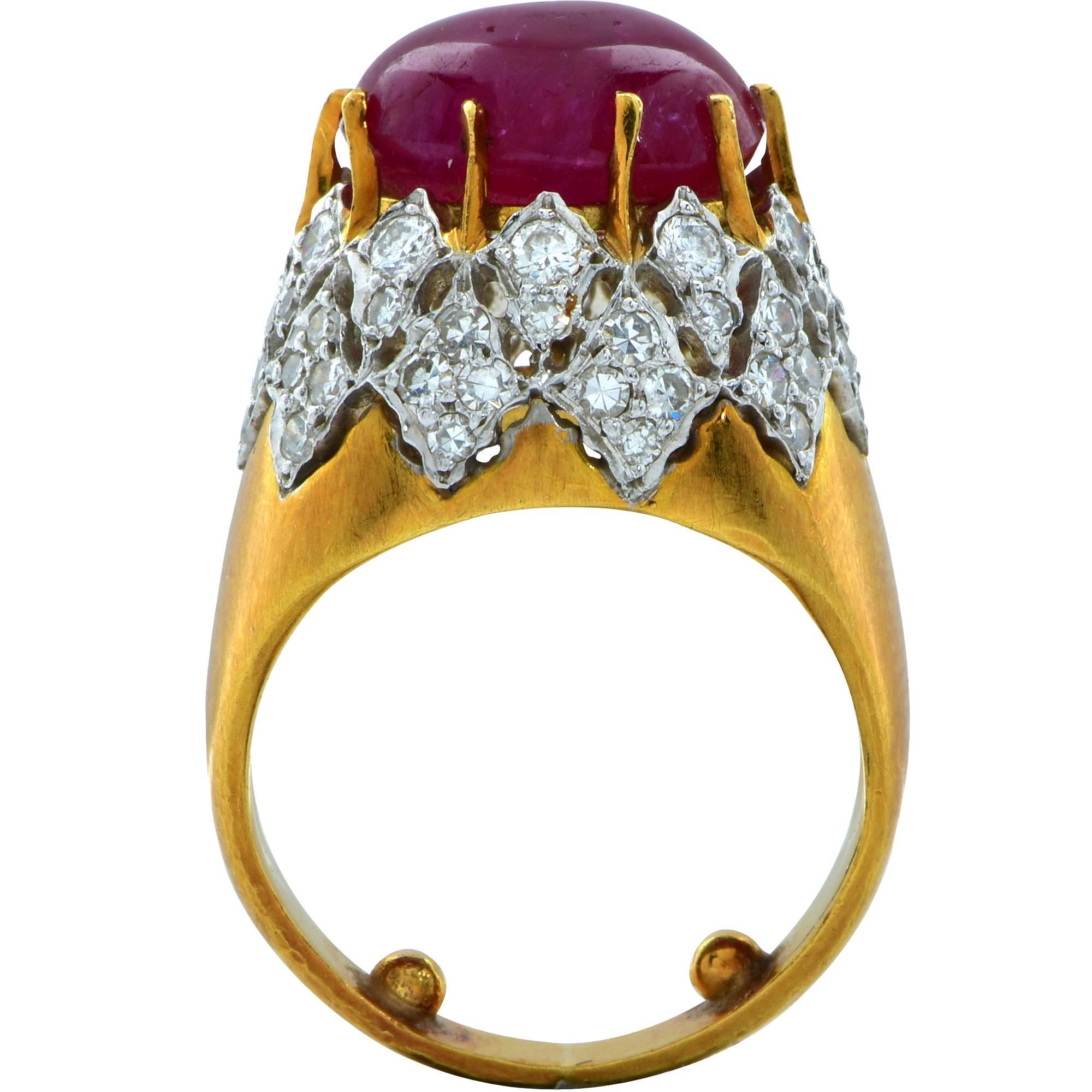 18k yellow gold platinum ruby and diamond ring featuring a cabochon cut ruby weighing approximately 7.6cts set above platinum and 18k yellow gold accented by 60 round brilliant and single cut diamonds weighing approximately 1.15cts, H color, VS