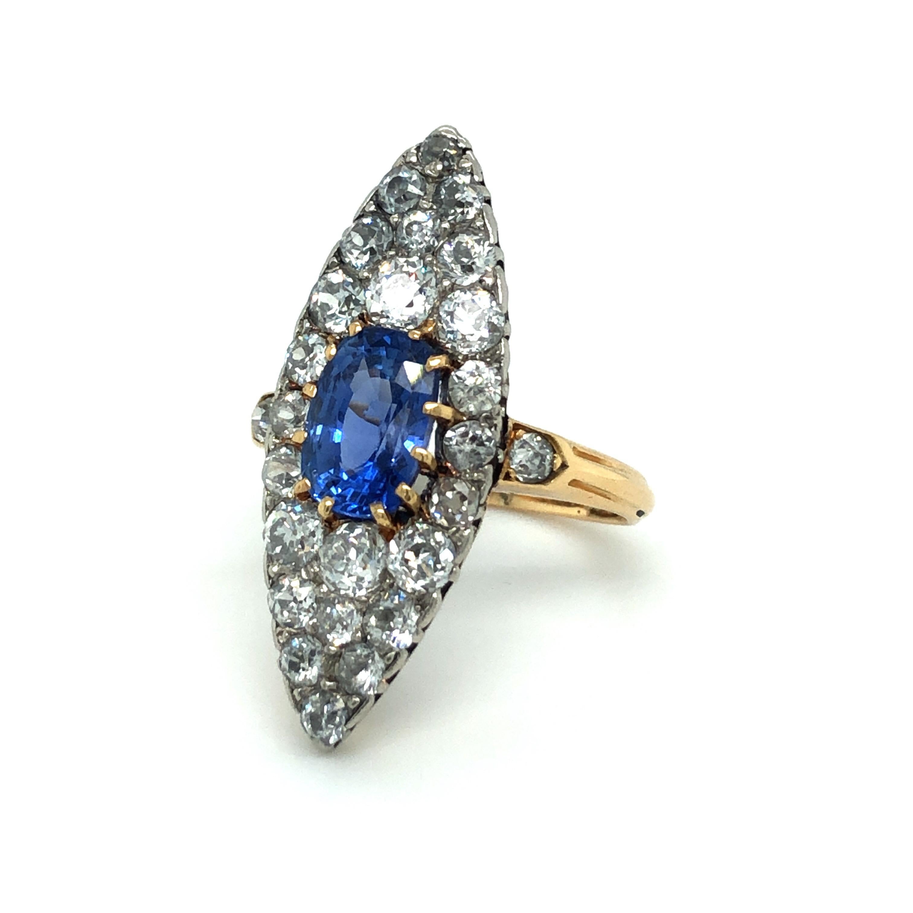Stunning 18 karat yellow gold platinum sapphire diamond dress cocktail ring, circa 1905.
This fairy-tale jewel is crafted in 18 karat yellow gold with platinum and features a marquise-shaped plaque set with a cushion-shaped sapphire of circa 2.5