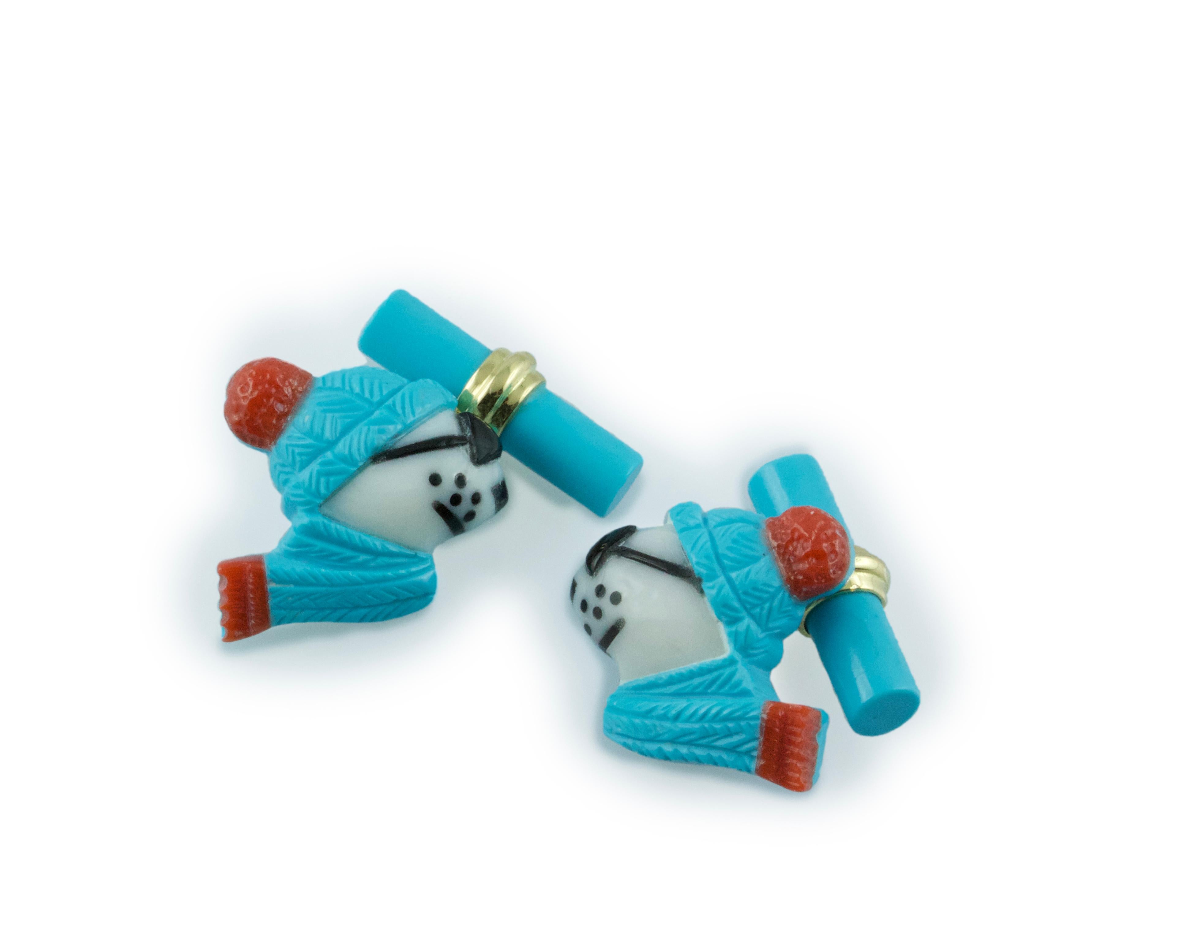 This playful pair of cufflinks depicts the profile of a polar bear portrayed as if dressed up for the winter with sunglasses, scarf, and hat. The animal is made of turquoise  which is also used to make the cylindrical toggle, accents in coral. The