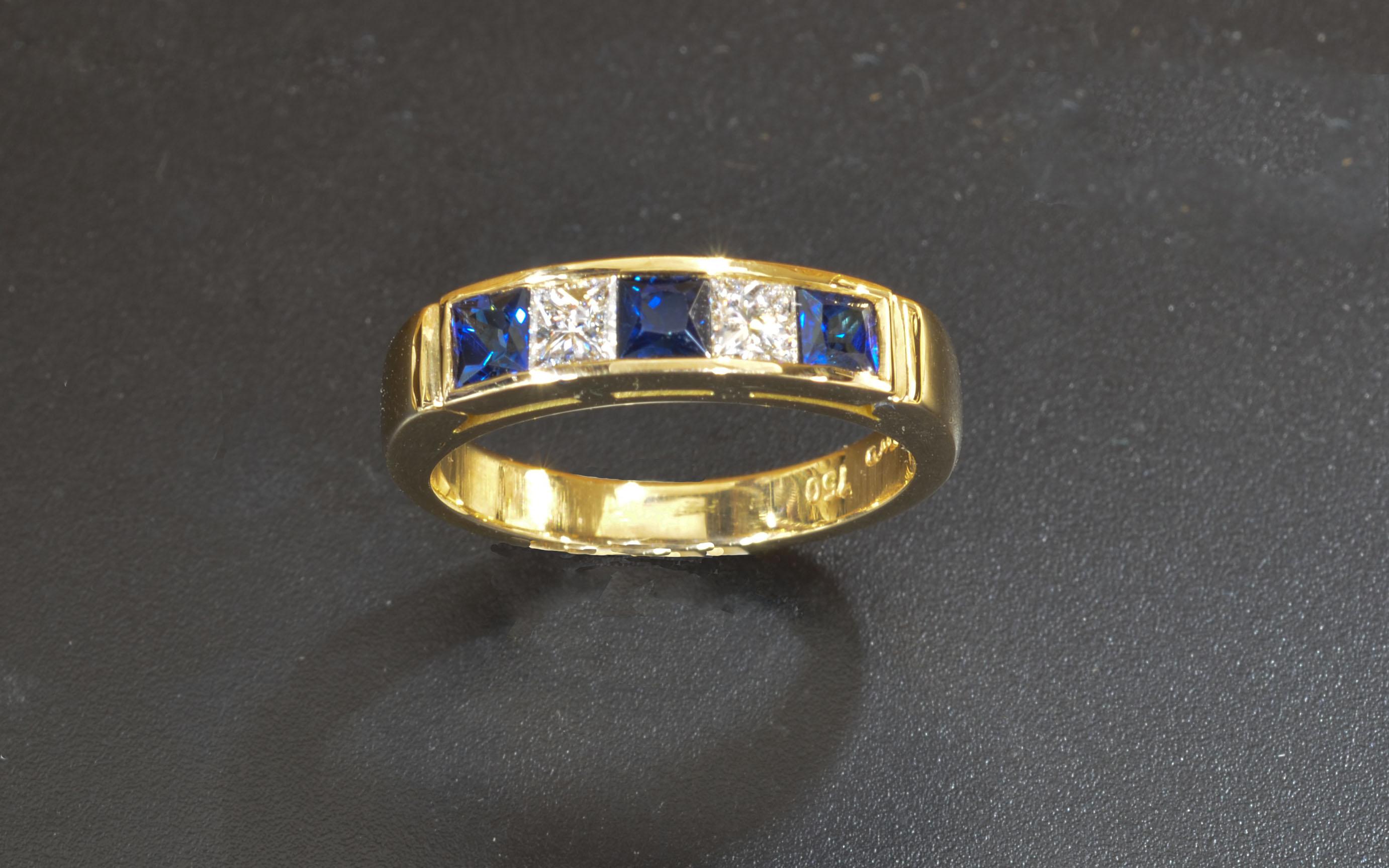 18 Karat Yellow Gold Princess Cut  Diamond and Sapphire Band. this ring is hand made at my studio in Maine. It features three (3mm each) Princess cut fine Sapphires and two (3MM each) Princess cut Diamonds, channel set. a very comfortable, easy to