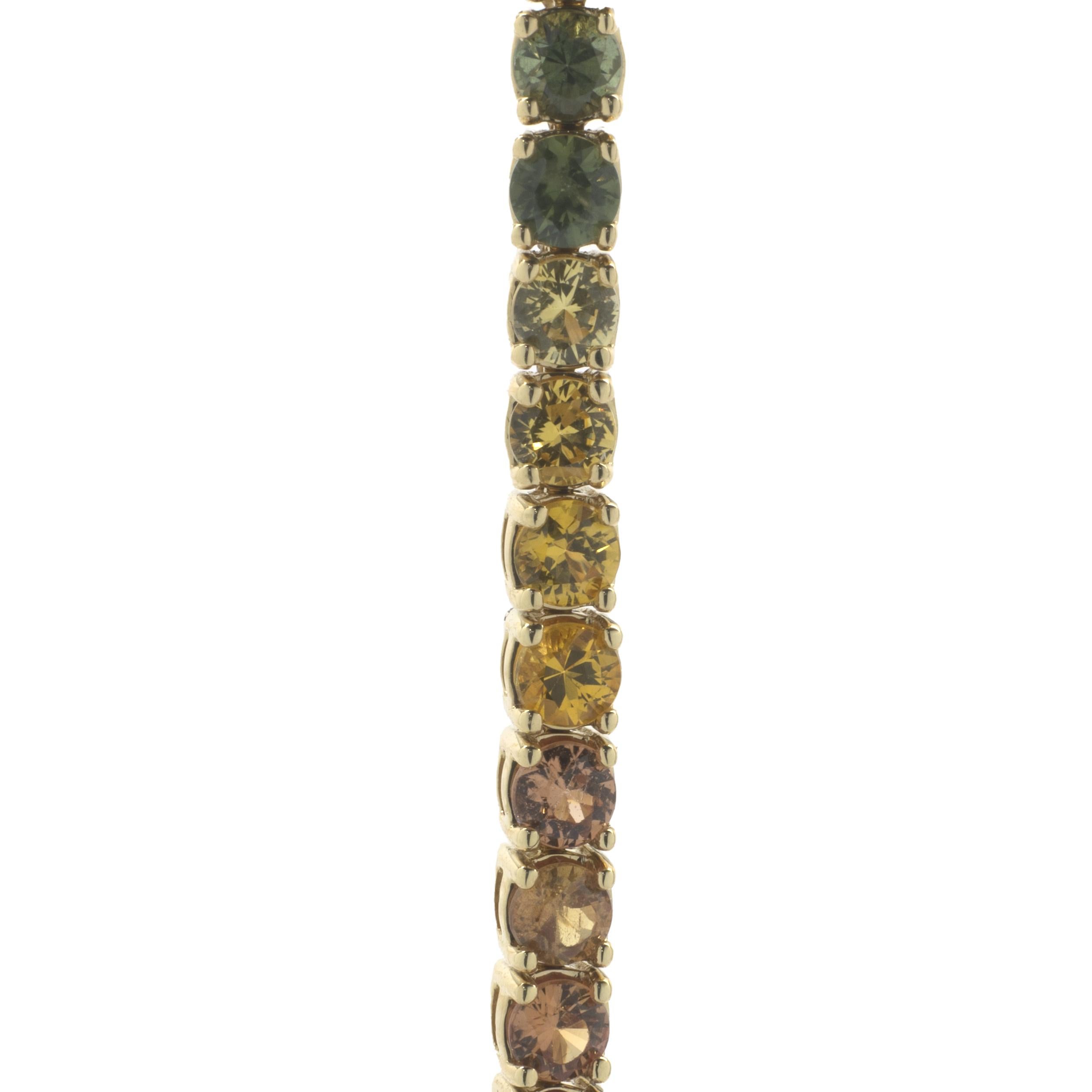 Designer: custom 
Material: 18K yellow gold
Sapphire: 59 round cut = 5.78cttw
Dimensions: bracelet will fit up to a 7-inch wrist
Weight: 13.26 grams
