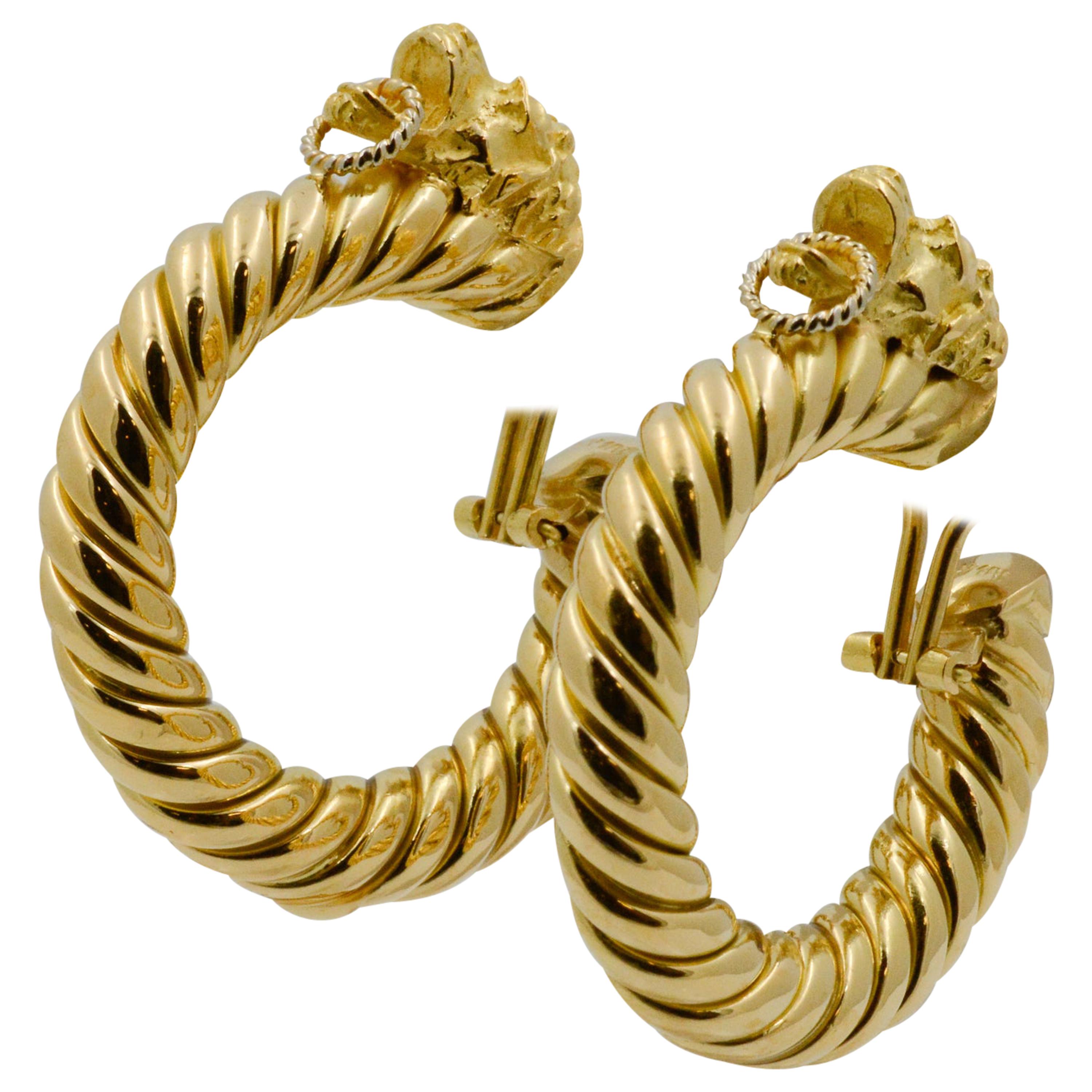Exclusively from the Eiseman Estate Jewelry Collection, these 18k yellow gold earrings feature a ram head and rope design throughout the hoop. The earrings are stamped Italy Mecan. 