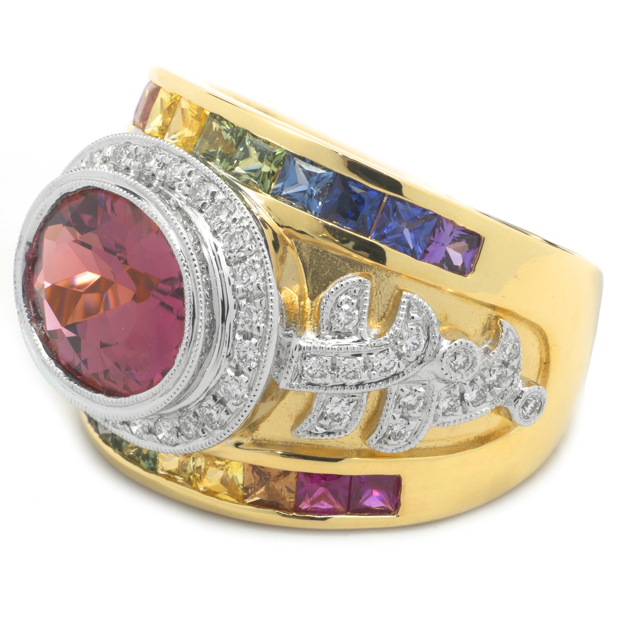 Designer: custom
Material: 18K yellow gold
Diamonds: 52 round brilliant cut = .39cttw 
Color: G
Clarity: VS
Sapphire: 22 square cut = 1.35cttw
Color: Purple, Blue, Green, Yellow, Orange, Pink (Rainbow)
Salmon Tourmaline: 1 oval cut = 2.96ct
Ring