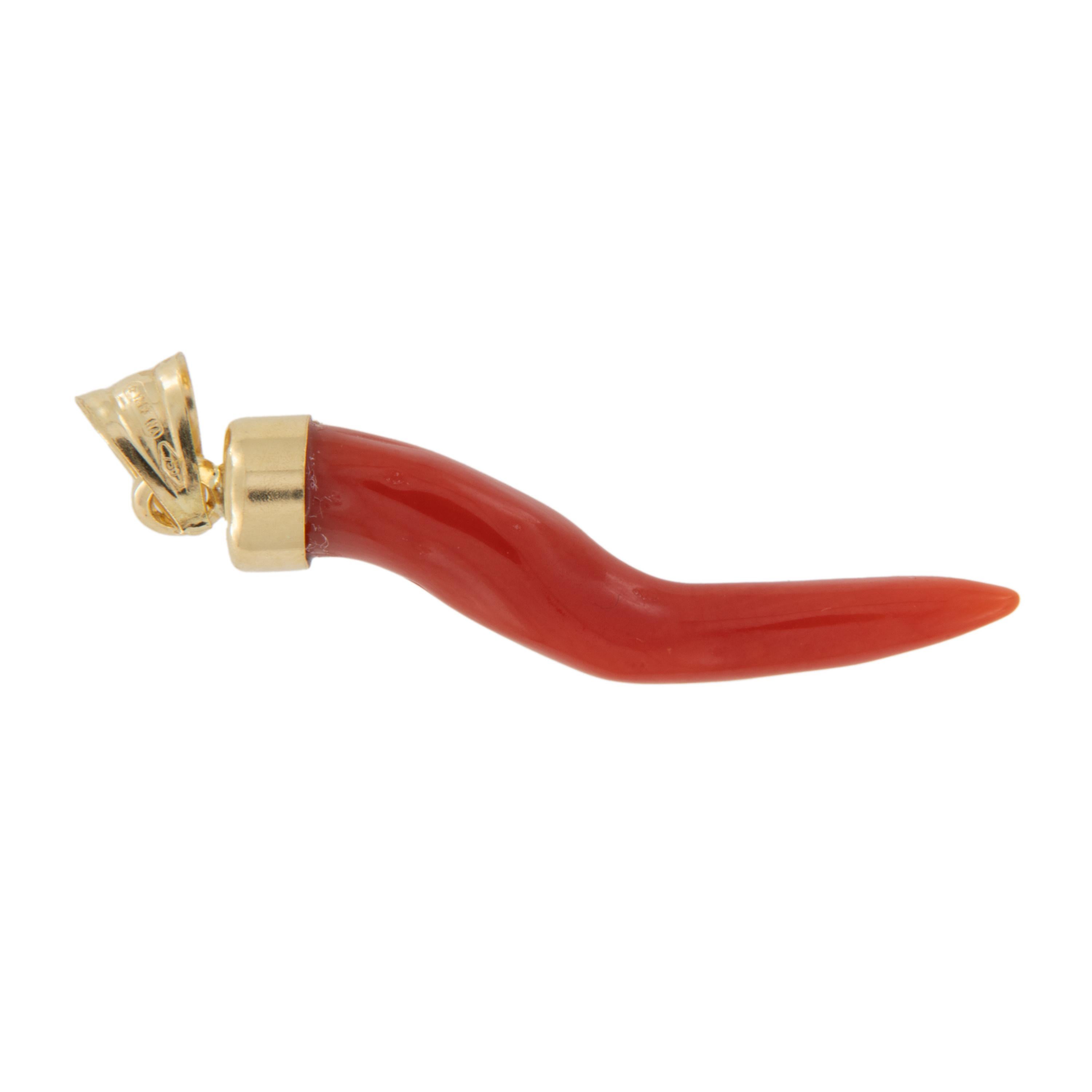 The Italian horn is a symbol of good luck and is believed to protect the wearer. Why not look stylish while wearing it? Made of exceptional red Mediterranean coral that is set off by the rich 18 karat yellow gold holding it. Limited quantity, get