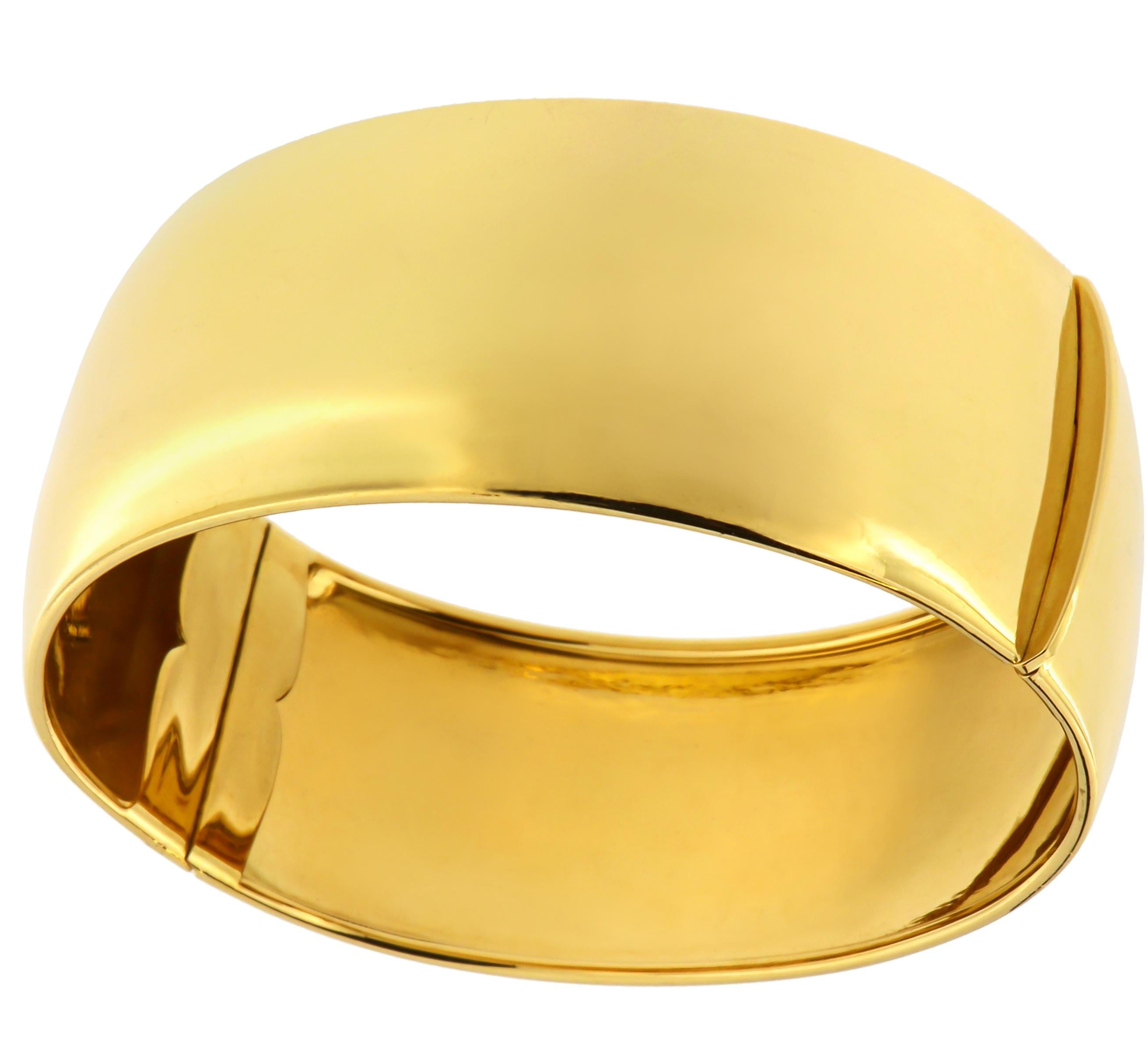 1980s Cuff Bracelet in 18k yellow gold. The bracelet width is 25 mm / 0.984 inches. The inner dimension of the bracelet is 60 x 55 mm / 2.362 x 2.165 inches. It is handcrafted in Italy and marked with the Italian Gold Mark 750 and brandmark