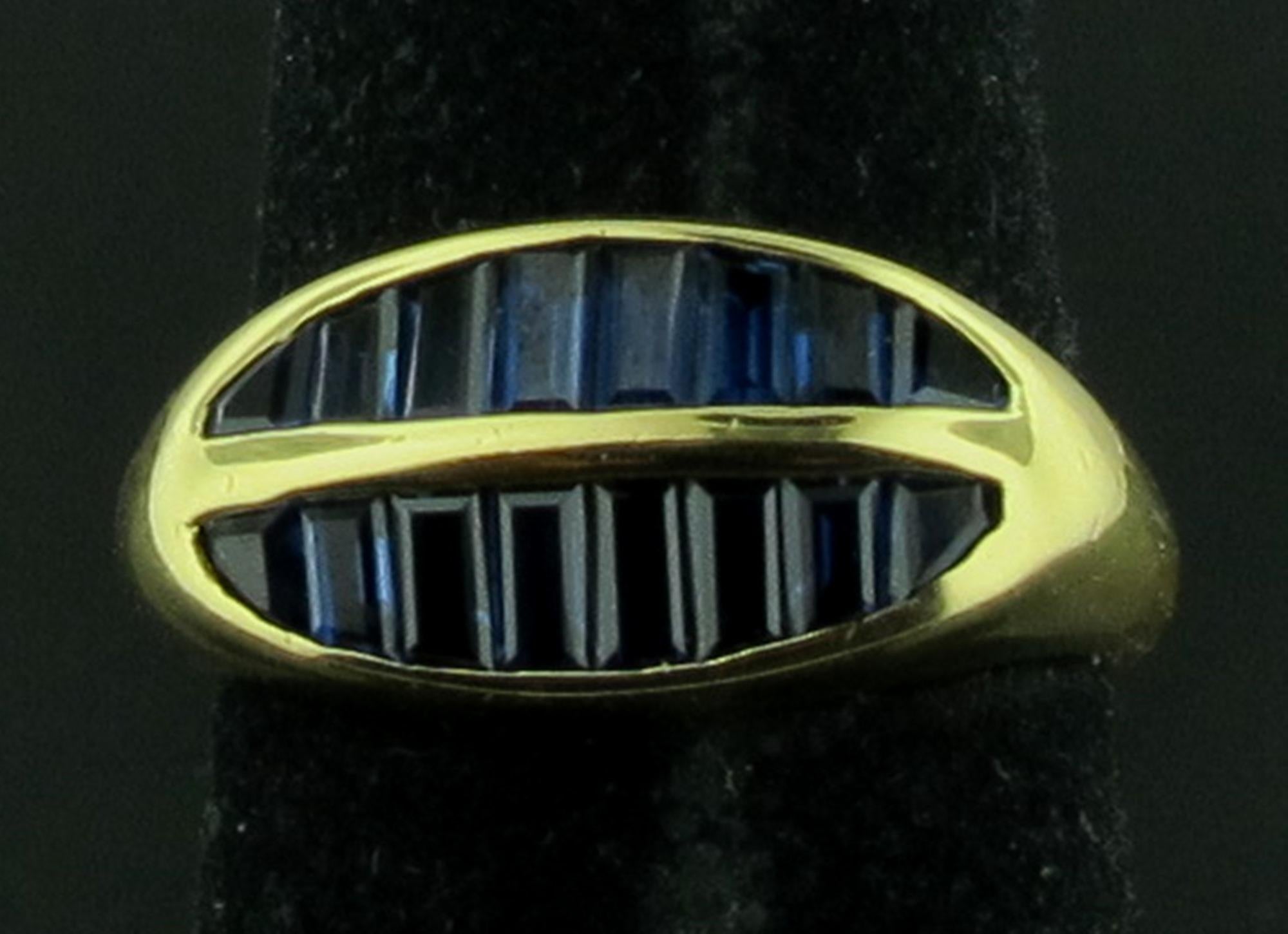 Set in 18 karat yellow gold are 16 baguette cut blue Sapphires.  Sapphire weight is 1.25 carats.  Gold weight is 6 grams.  Ring size is 6.
