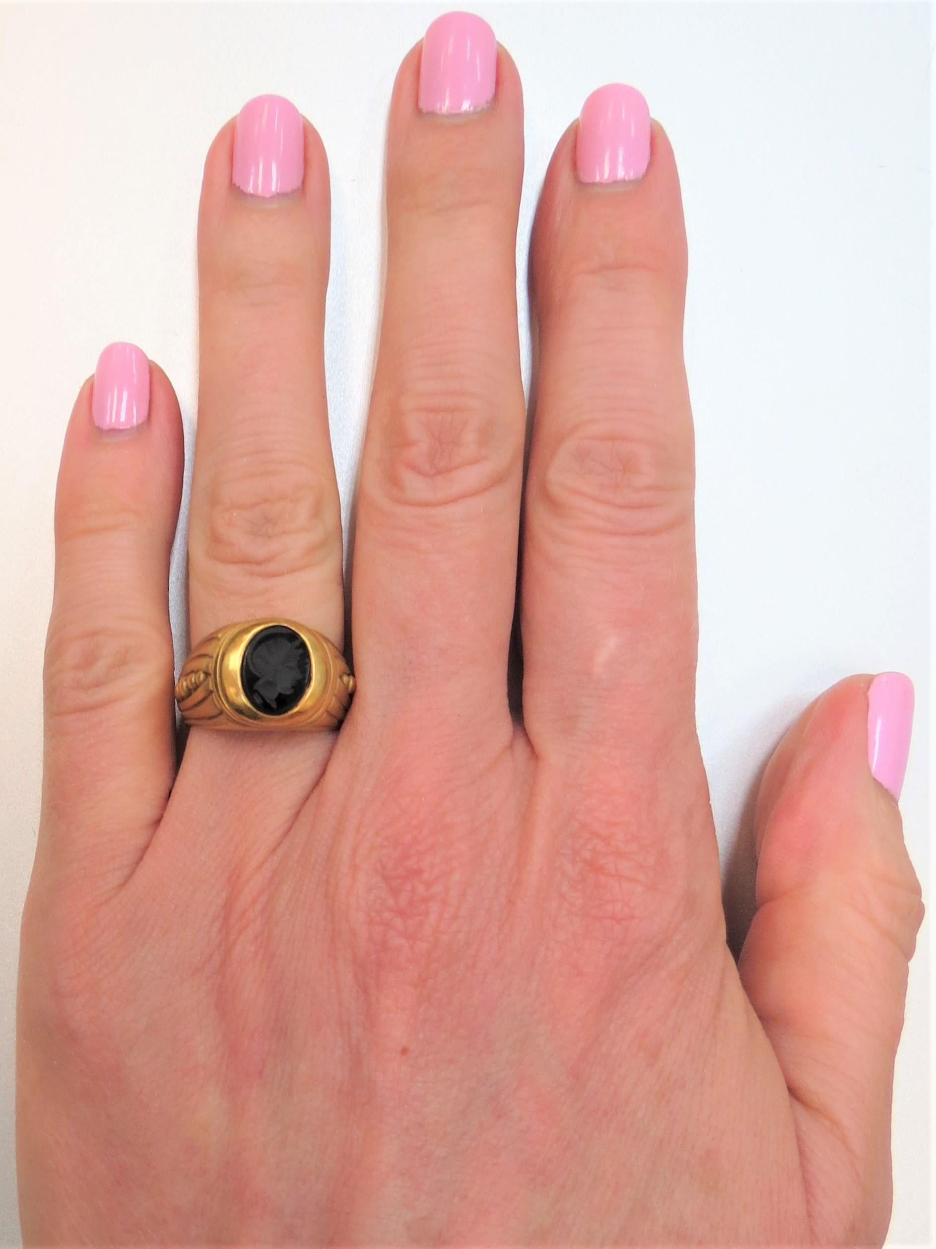 18K yellow gold ring, matte gold finish, set in center with one oval piece of carved black onyx Intaglio
Finger size 6, may be sized