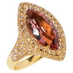 18 karat yellow gold ring with marquise cut tourmaline and pave set diamonds