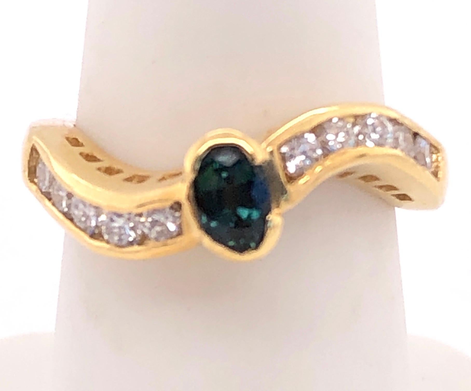 Oval Cut 18 Karat Yellow Gold Ring with Sapphire Center and Diamond Accents 0.80 TDW For Sale