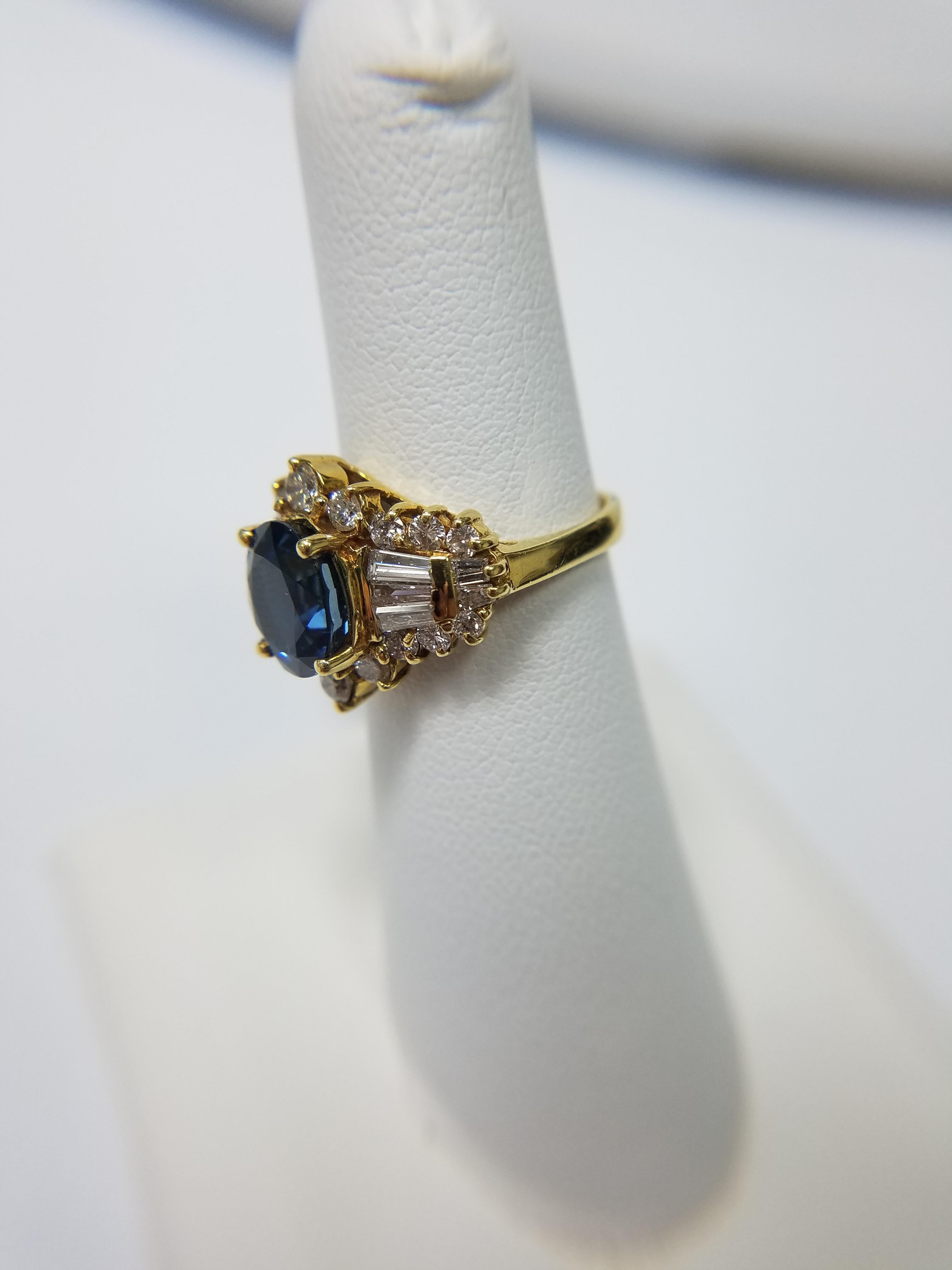 18K yellow gold rind with aprox 1.25 carat sapphire center stone and aprox. 2.50 carats in diamond side stones. 