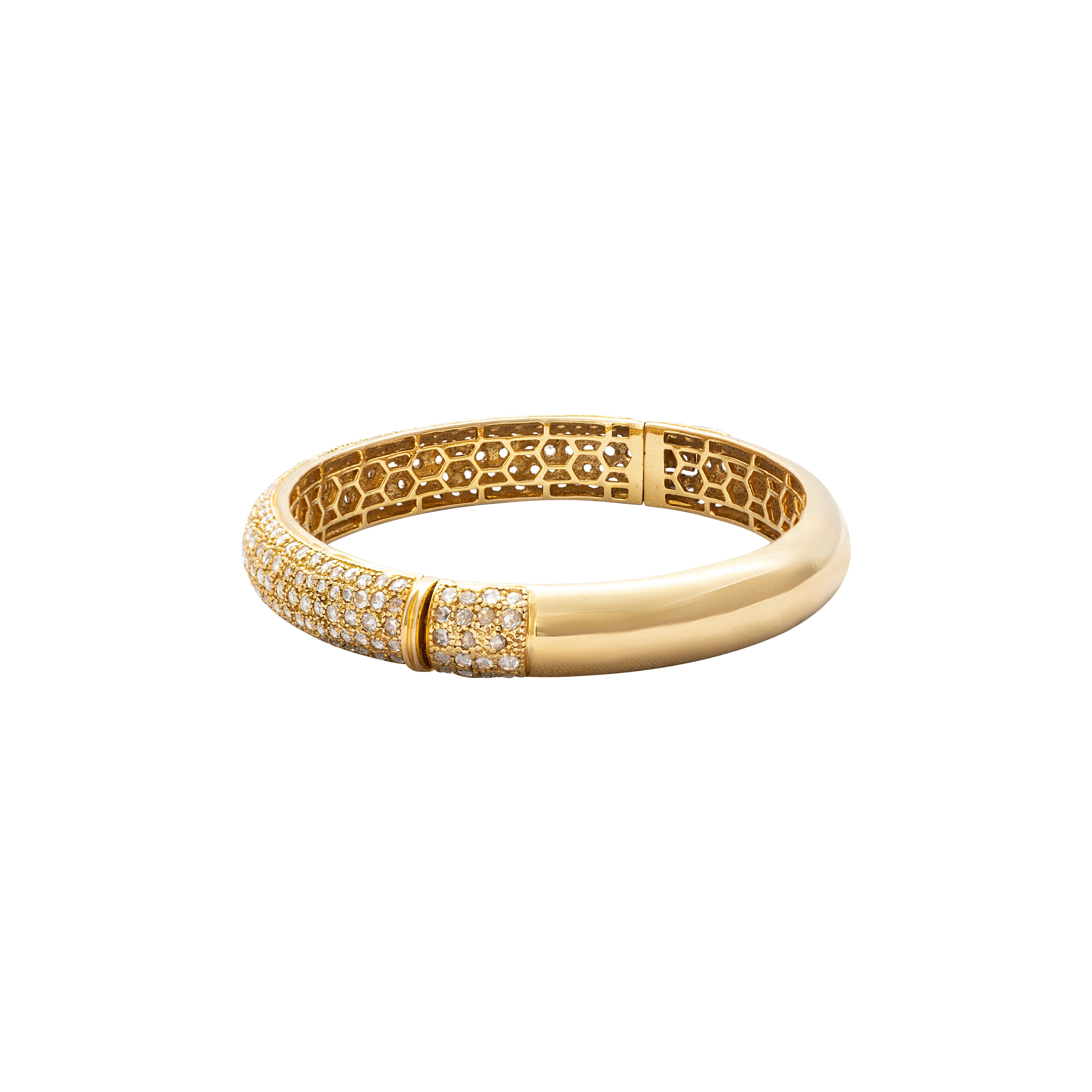 18 Karat Yellow Gold Rosecut Diamond Cuff Bracelet

Beautifully crafted cuff bracelet, set in 18 Karat yellow gold studded with rosecut diamonds. The honeycomb design on the inside is indicative of the workmanship and design that sets this bracelet