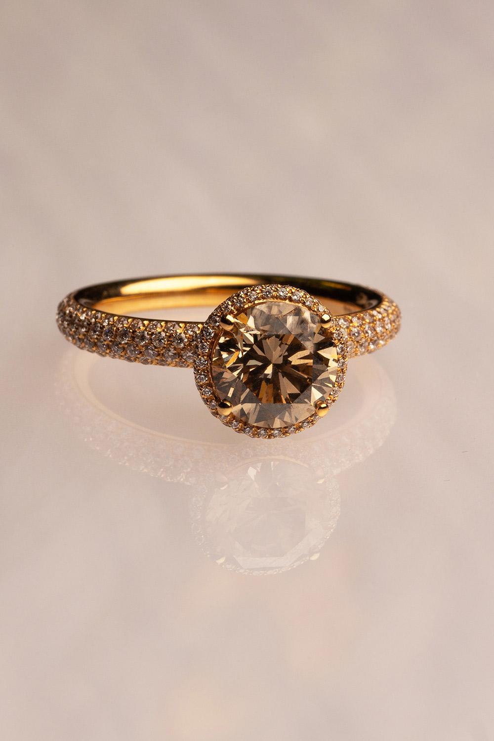 This 18K yellow gold stunning cocktail ring is from our Divine Collection. The centre stone is round shape brown diamond in total of 2.05 Carat which is decorate by round colorless diamonds in total of 0.60 Carat. Total metal weight is 4.97 gr.
