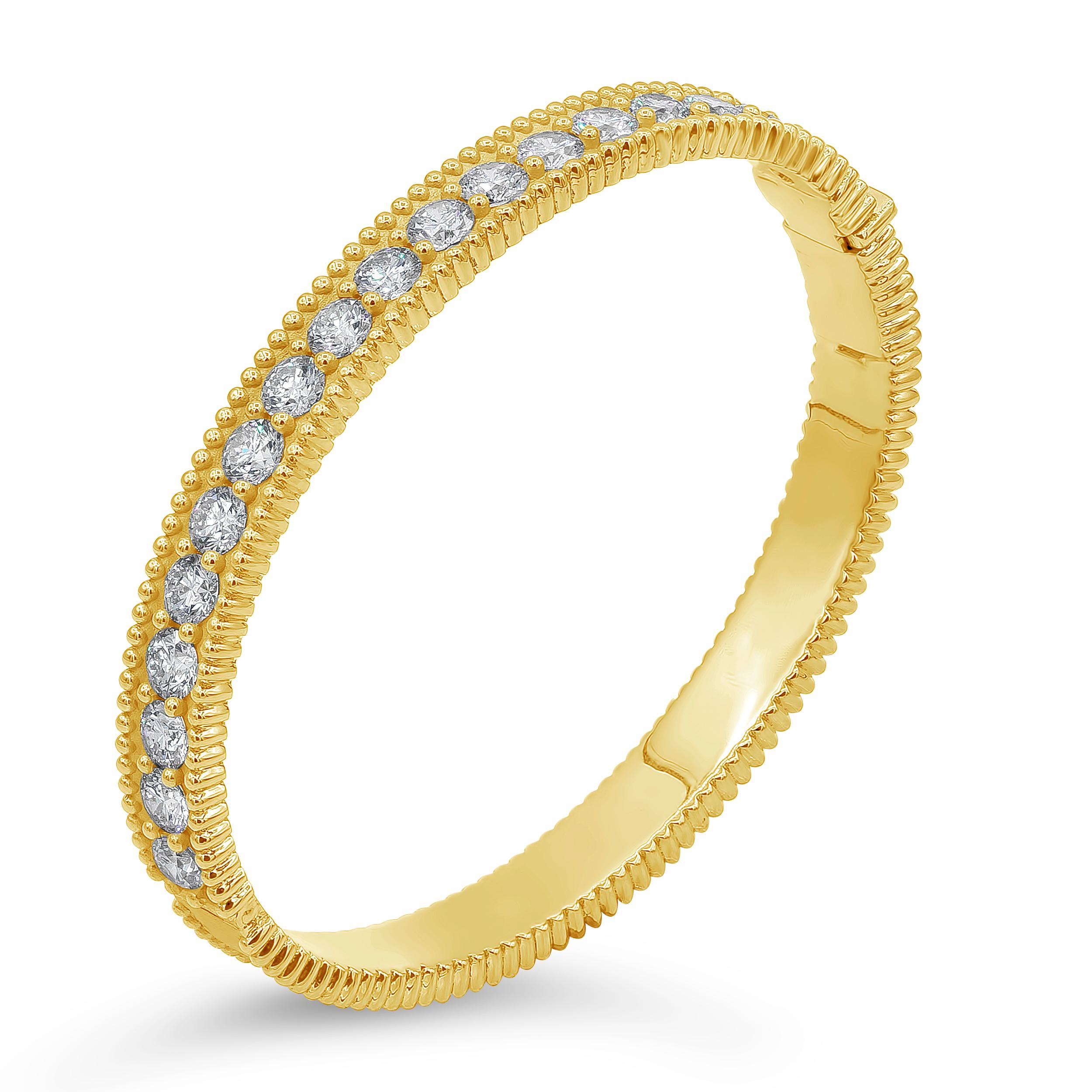A brilliant and stylish bangle bracelet showcasing a row of  18 pieces of round brilliant diamonds weighing 5.68 carat total, F Color and SI2-3 in Clarity. Set in shared prongs, all the way around the 18K Yellow Gold mounting. Finished with beaded