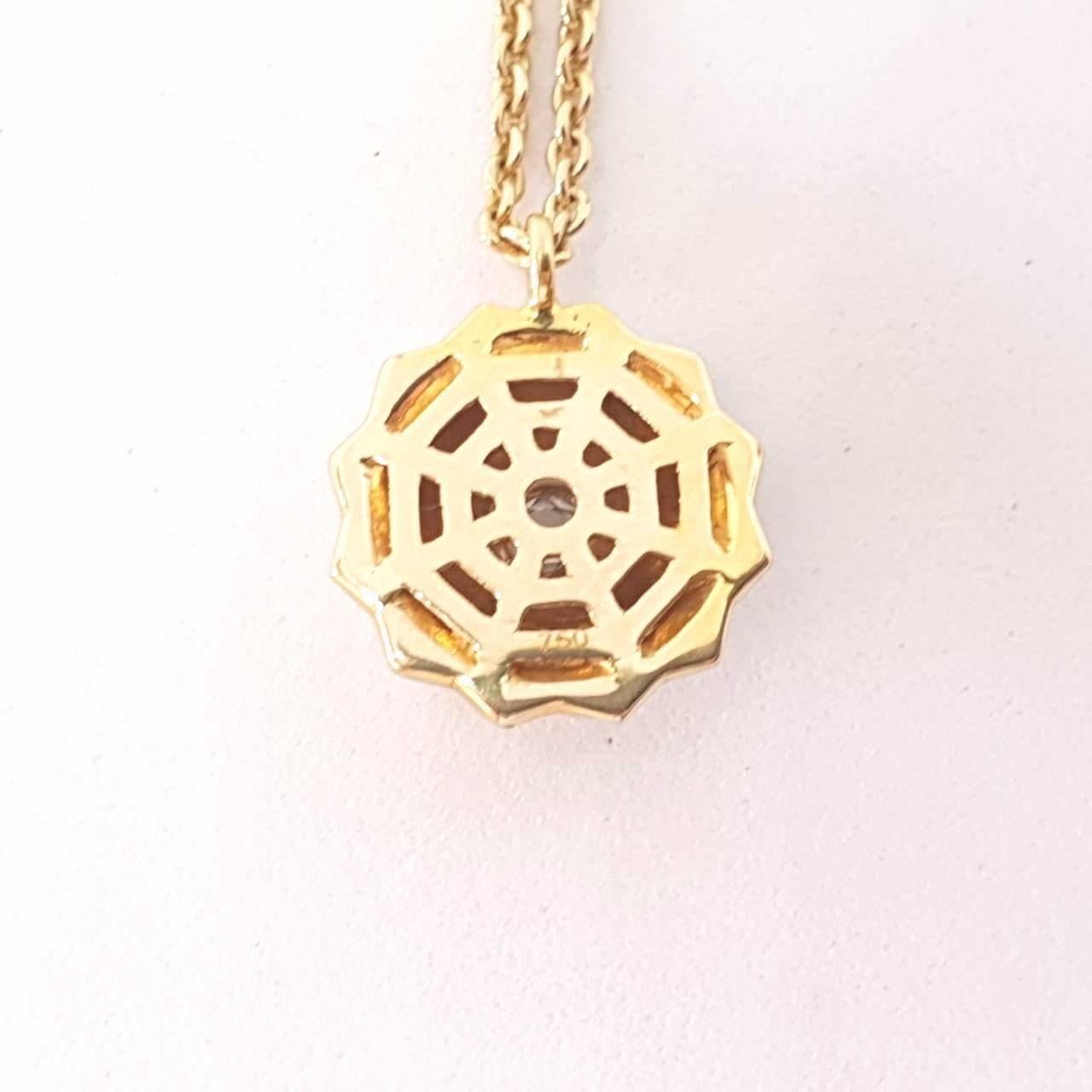Depicting the circle of life, this day wear pendant necklace is made in 18 Karat Yellow Gold & studded with 1 centre round shape rose cut diamond. 
The hand texture, the backplate & the diamond rings in the chain add to the detail in this pendant