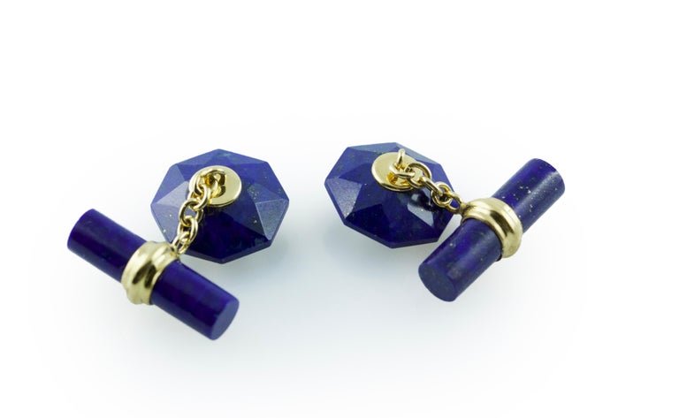 The striking blue shade of Lapis Lazuli gives the classic design of these cufflinks a modern edge. The front face is shaped as a convex octagon, whose many cuts beautifully reflect light, while the center is adorned with a cabochon ruby. 
The