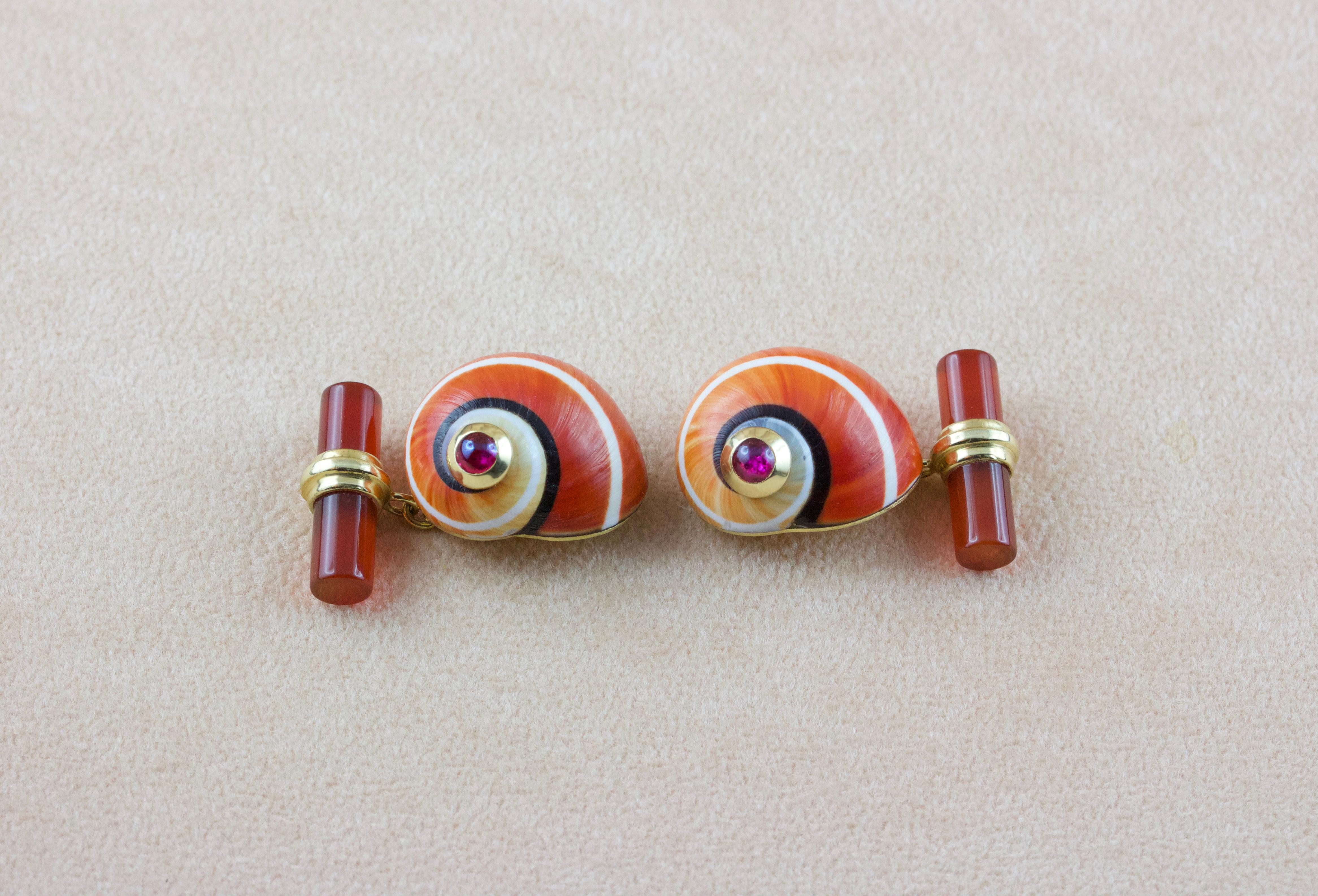 This charming pair of cufflinks is made by shell adorned with a cabochon ruby at its top. 
A post in 18 karat yellow gold connects this front face to the toggle, which is made of carnelian.

All AVGVSTA jewelry is new and has never been previously