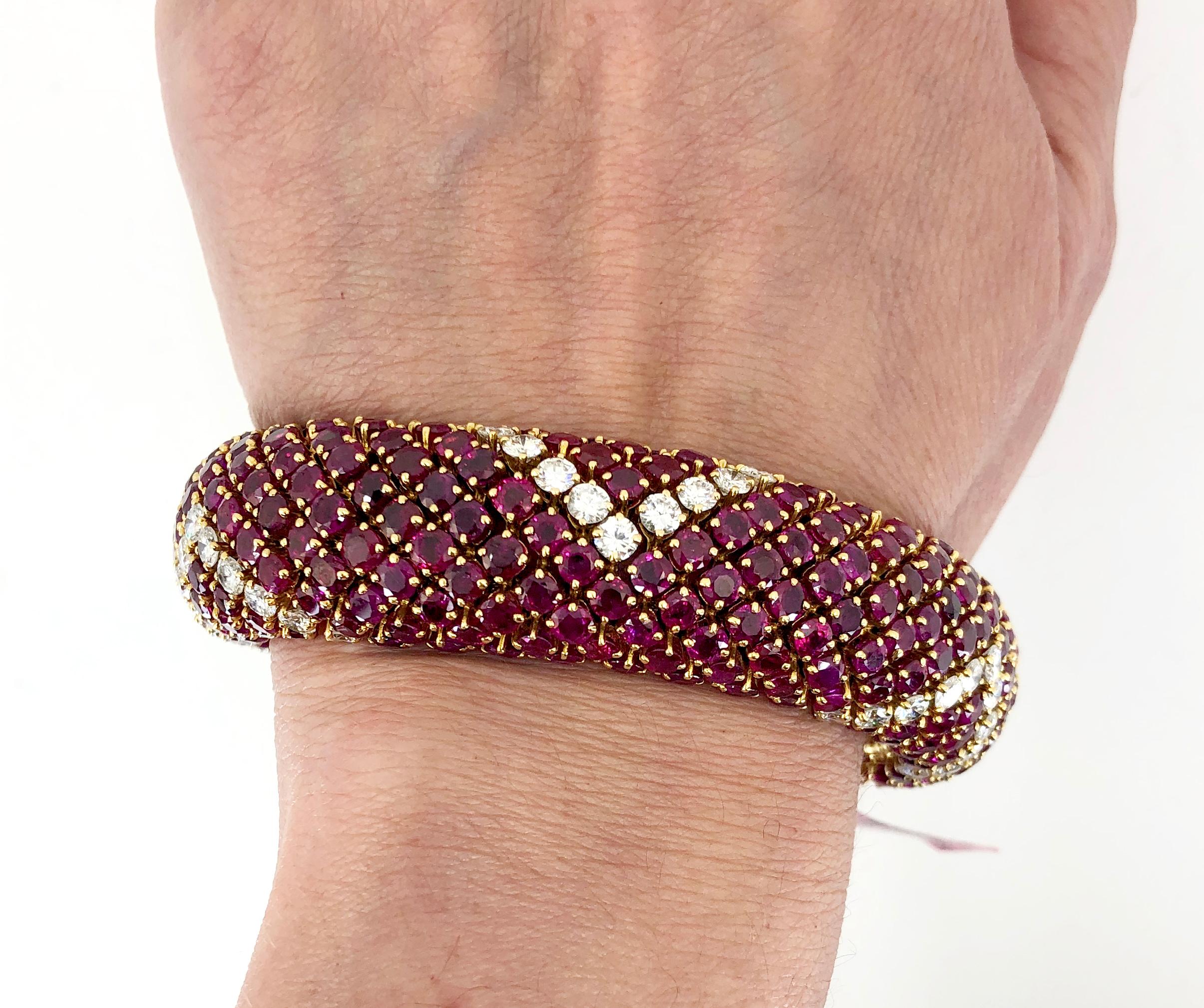 Retro-Style Ruby Diamond Bombe Bracelet in 18k Yellow Gold.

This bejeweled retro-style bracelet is compiled by round brilliant rubies configured in a continuous bombé shape; all mounted in yellow gold. An angular geometric motif is intermittently