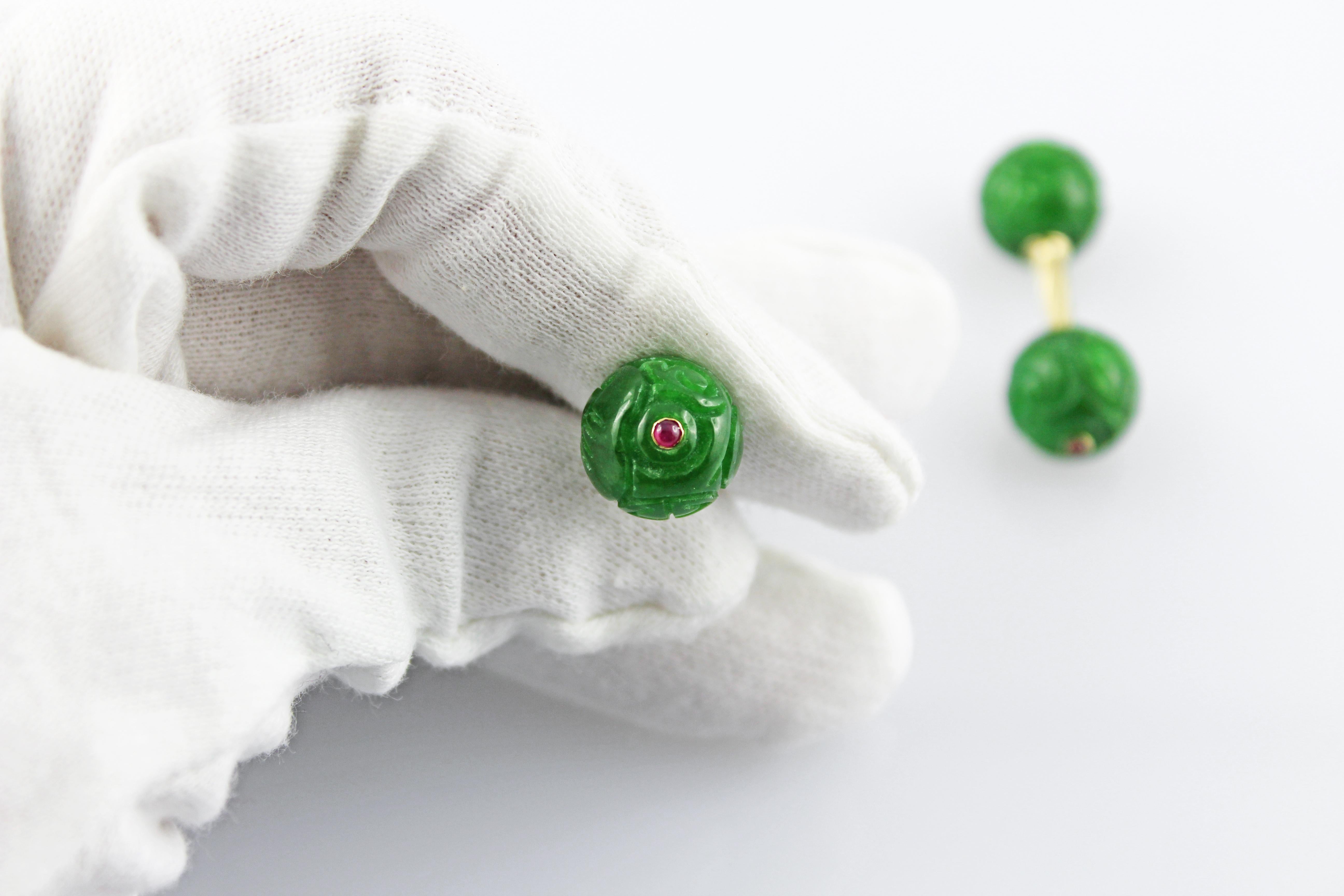 Simple and timeless, these cufflinks are a classic addition to any attire. 
Their front face and toggle are identical and are carved in a spherical engraved shape out of jade,  whose green shade strikingly complements the 18 karat yellow gold of the