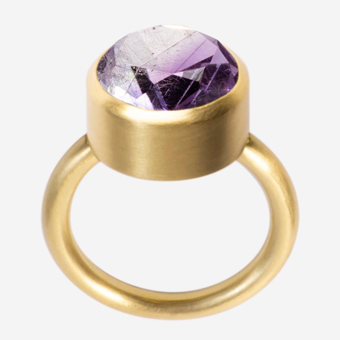 This bold and minimal statement ring is a modern take on the cocktail ring. It features a stone that is fashioned from two natural colored stones that have been fused together then cut and polished as one. When the two characteristics of the
