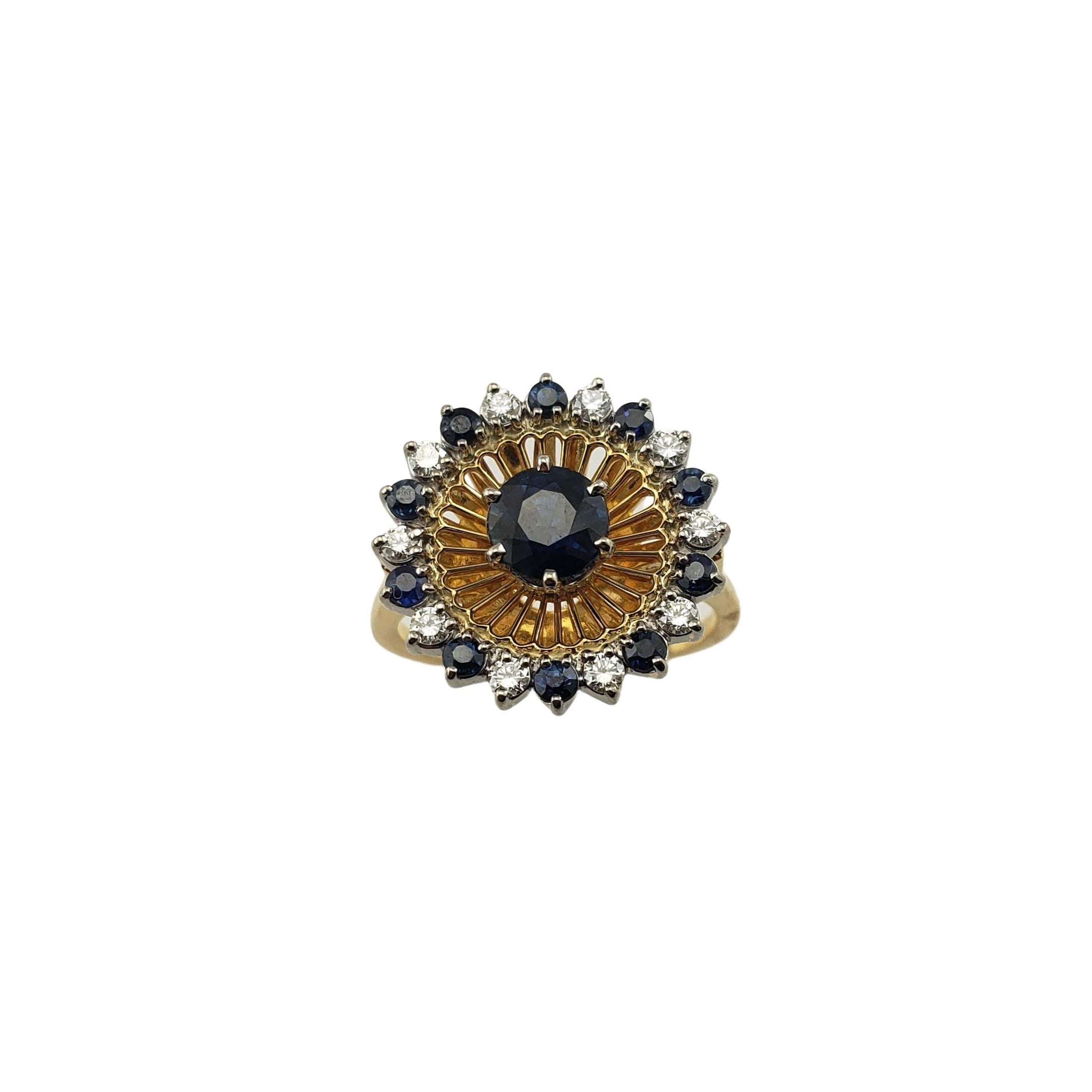 Vintage 18 Karat Yellow Gold Diamond and Natural Sapphire Ring Size 5-

This stunning ring features 10 round brilliant cut diamonds and 11 round natural sapphires (center: 5 mm) set in beautifully detailed 18K yellow gold.  Top of ring measures 16