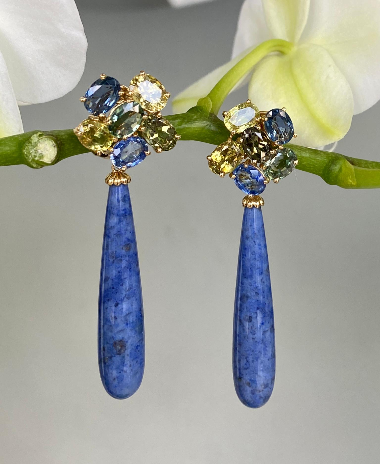Earrings of blue and green sapphires and chrysoberyl cluster tops with blue dumortierite quartz cabochon drops, handcrafted in 18 Karat yellow gold.

These beautiful one-of-a-kind earrings of multicolored sapphire and chrysoberyl clusters with long